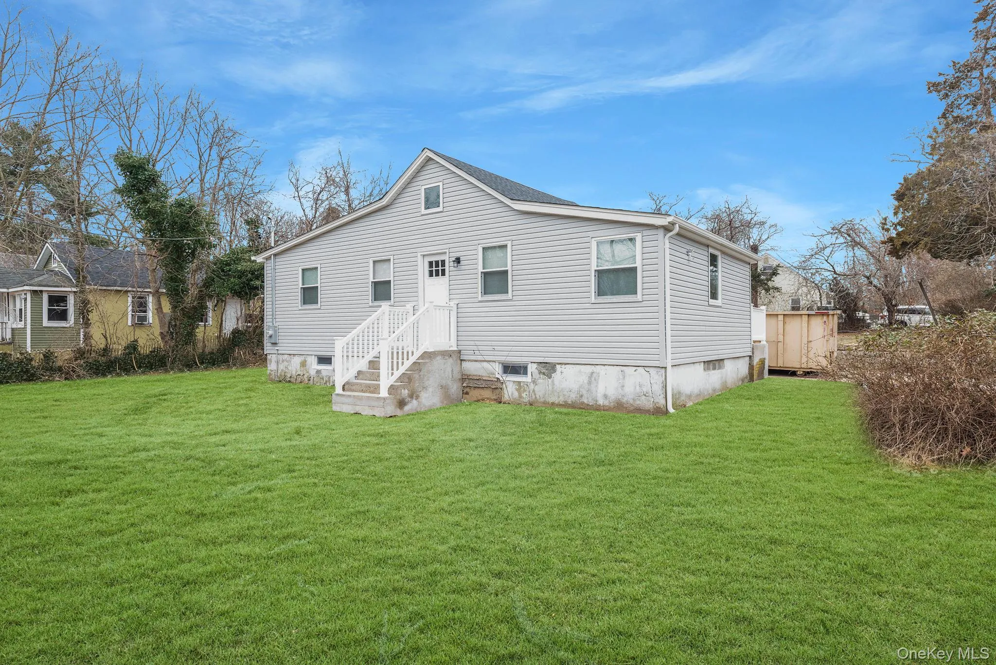 Back of house featuring a yard Back of house featuring a yard