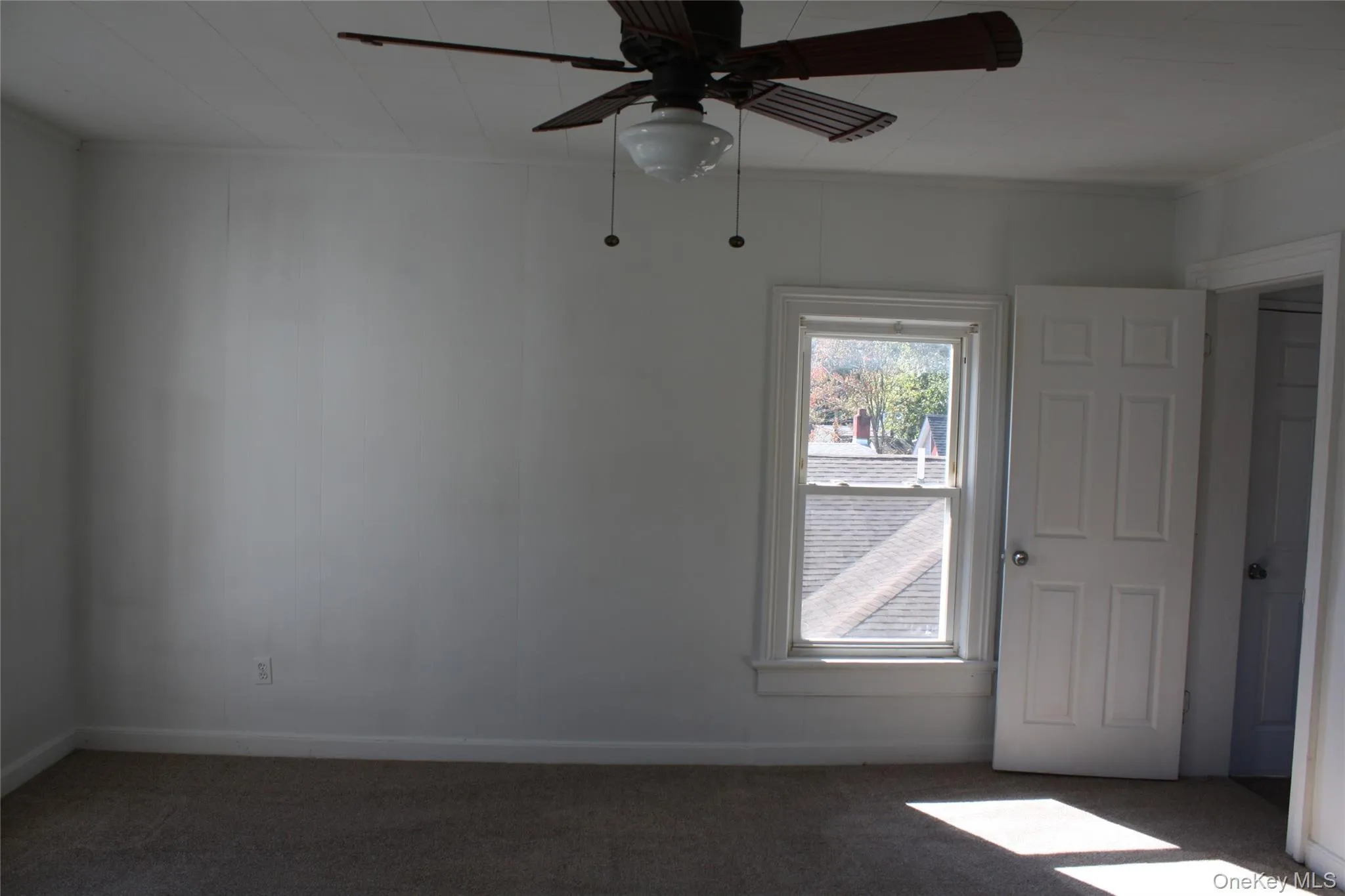 Spare room with carpet flooring, a ceiling fan, and crown molding Spare room with carpet flooring, a ceiling fan, and crown molding