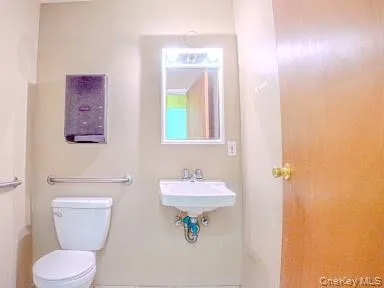 Half bath with toilet and tile patterned flooring Half bath with toilet and tile patterned flooring