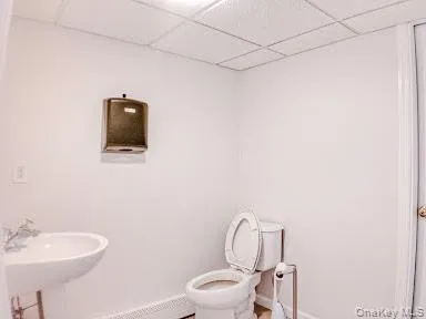 Bathroom with a paneled ceiling and tile patterned floors Bathroom with a paneled ceiling and tile patterned floors