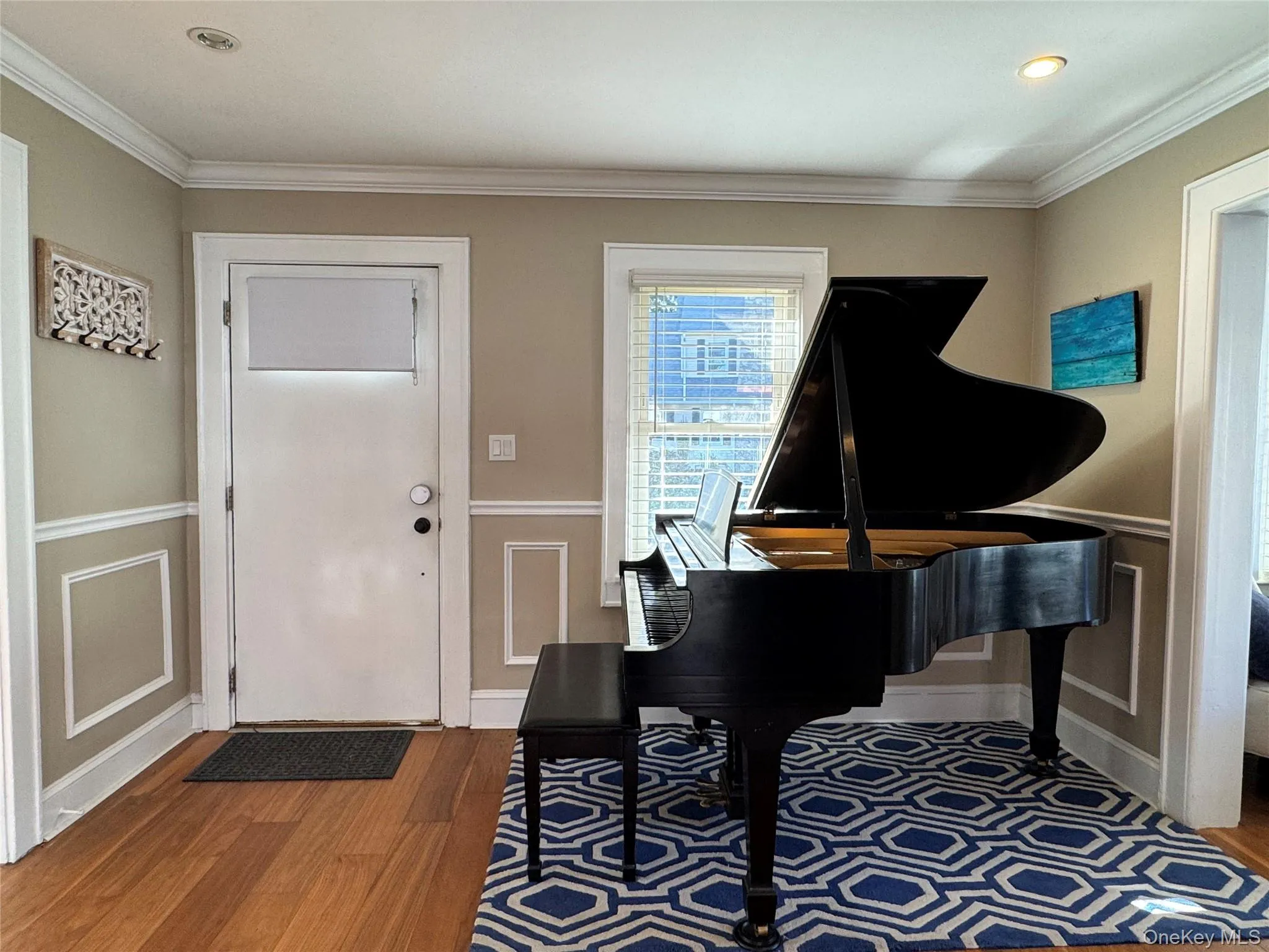 Entrance foyer featuring ornamental molding, dark wood-style floors, and recessed lighting Entrance foyer featuring ornamental molding, dark wood-style floors, and recessed lighting