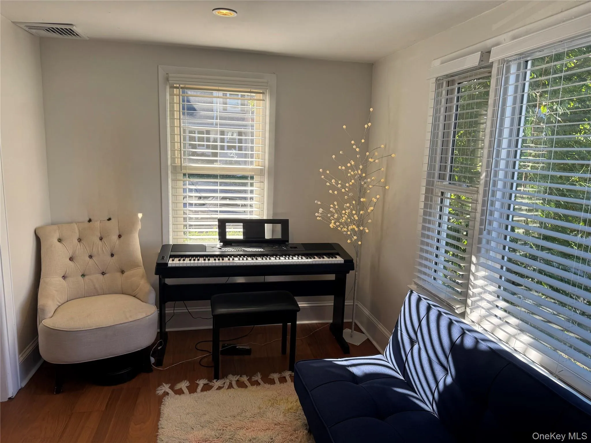 Living area featuring wood finished floors and baseboards Living area featuring wood finished floors and baseboards
