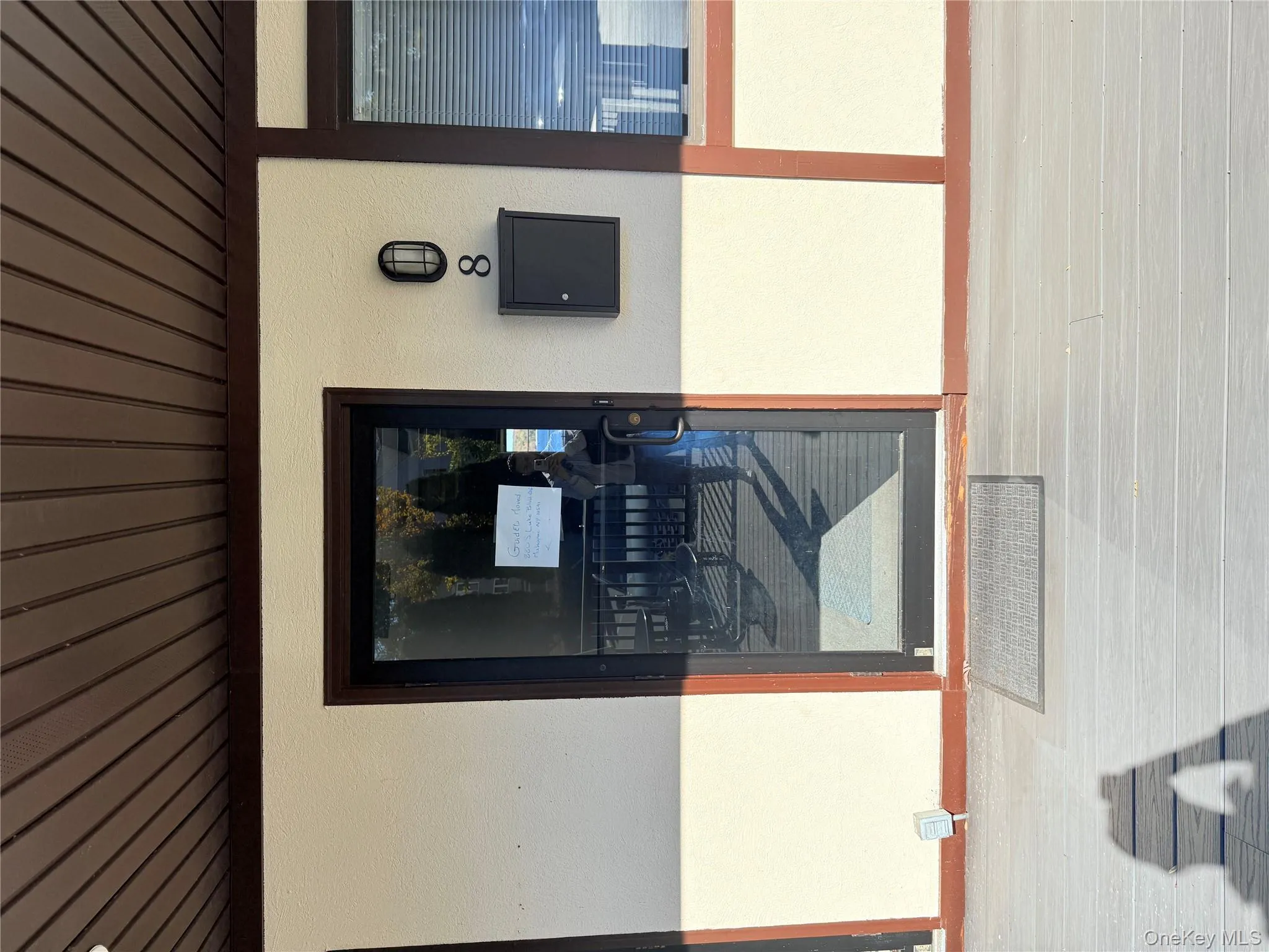 Property entrance featuring electric panel and stucco siding Property entrance featuring electric panel and stucco siding