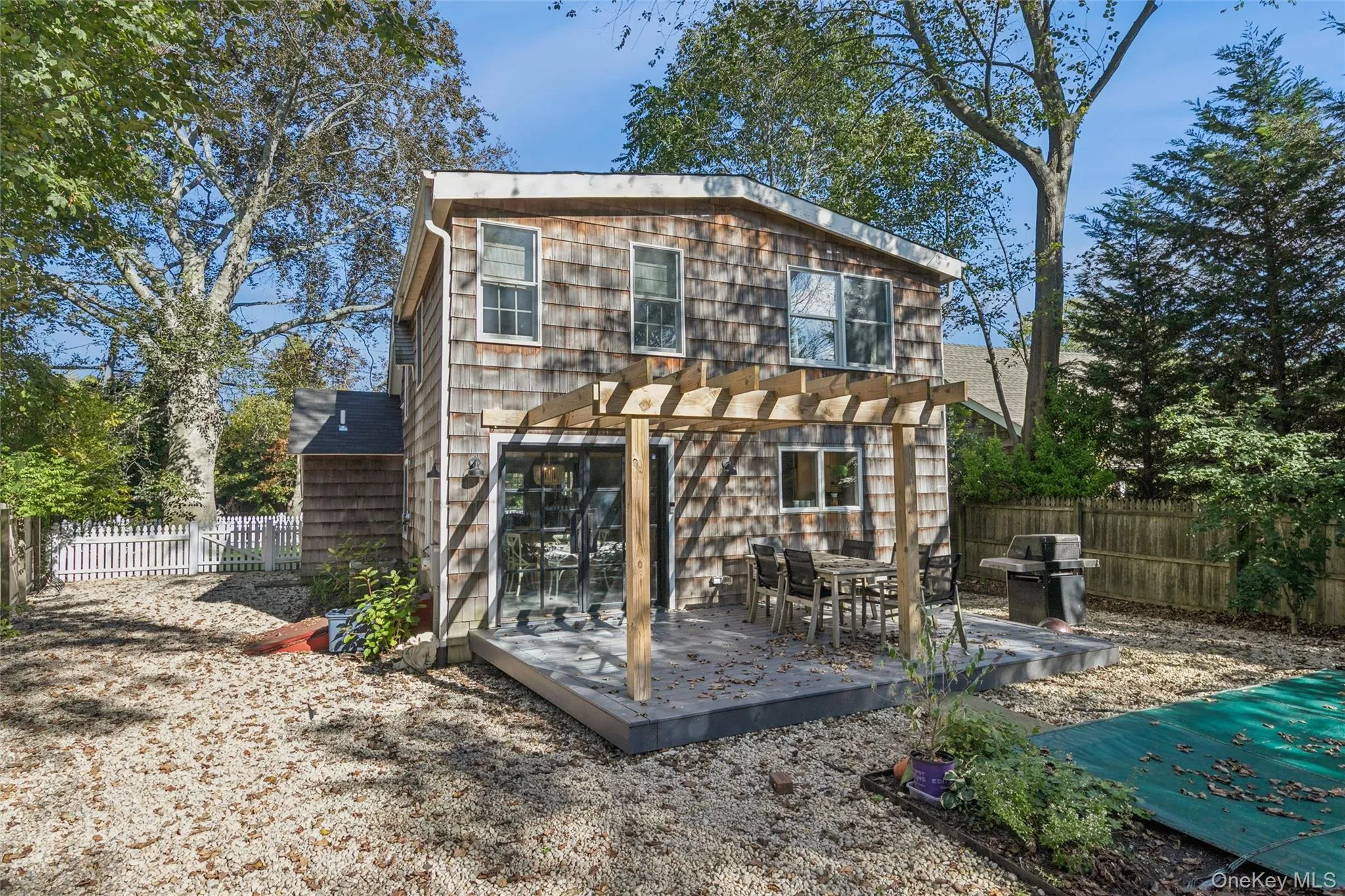 Rear view of house featuring a fenced backyard and a deck Rear view of house featuring a fenced backyard and a deck