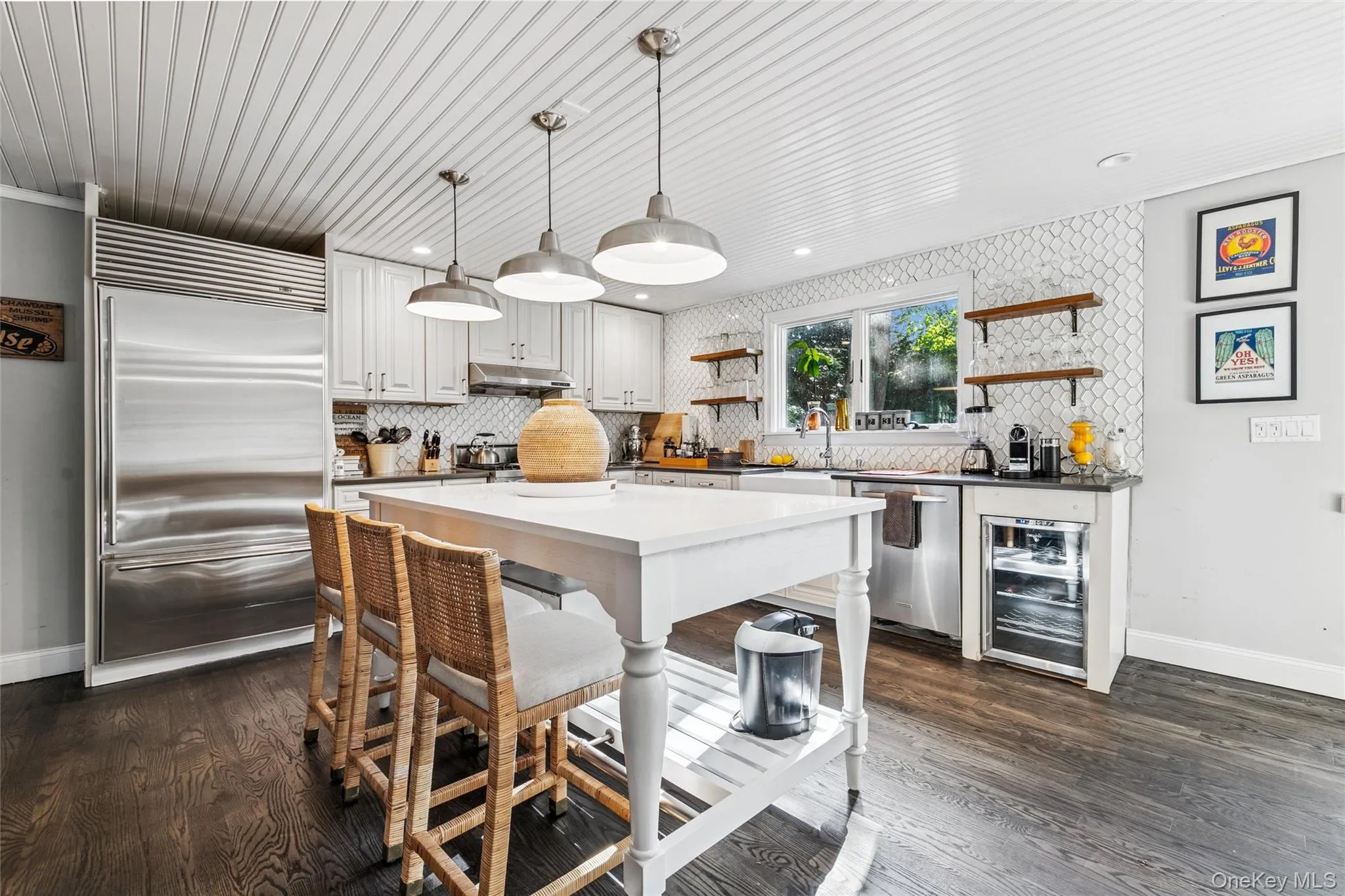 Kitchen with open shelves, appliances with stainless steel finishes, hanging light fixtures, and wine cooler Kitchen with open shelves, appliances with stainless steel finishes, hanging light fixtures, and wine cooler
