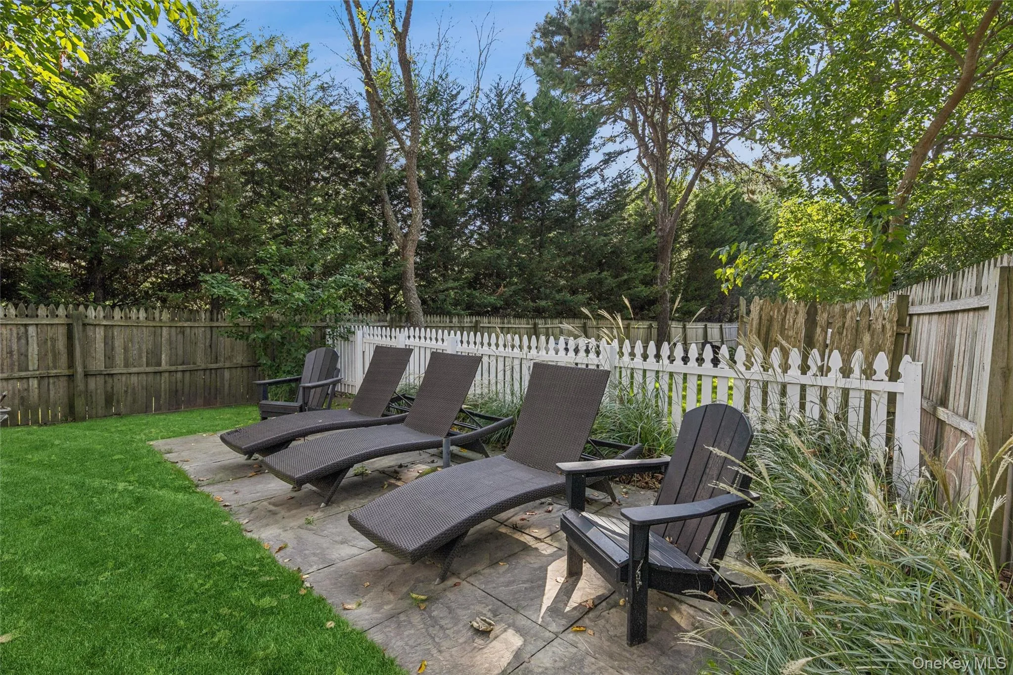 Fenced backyard featuring a patio area Fenced backyard featuring a patio area