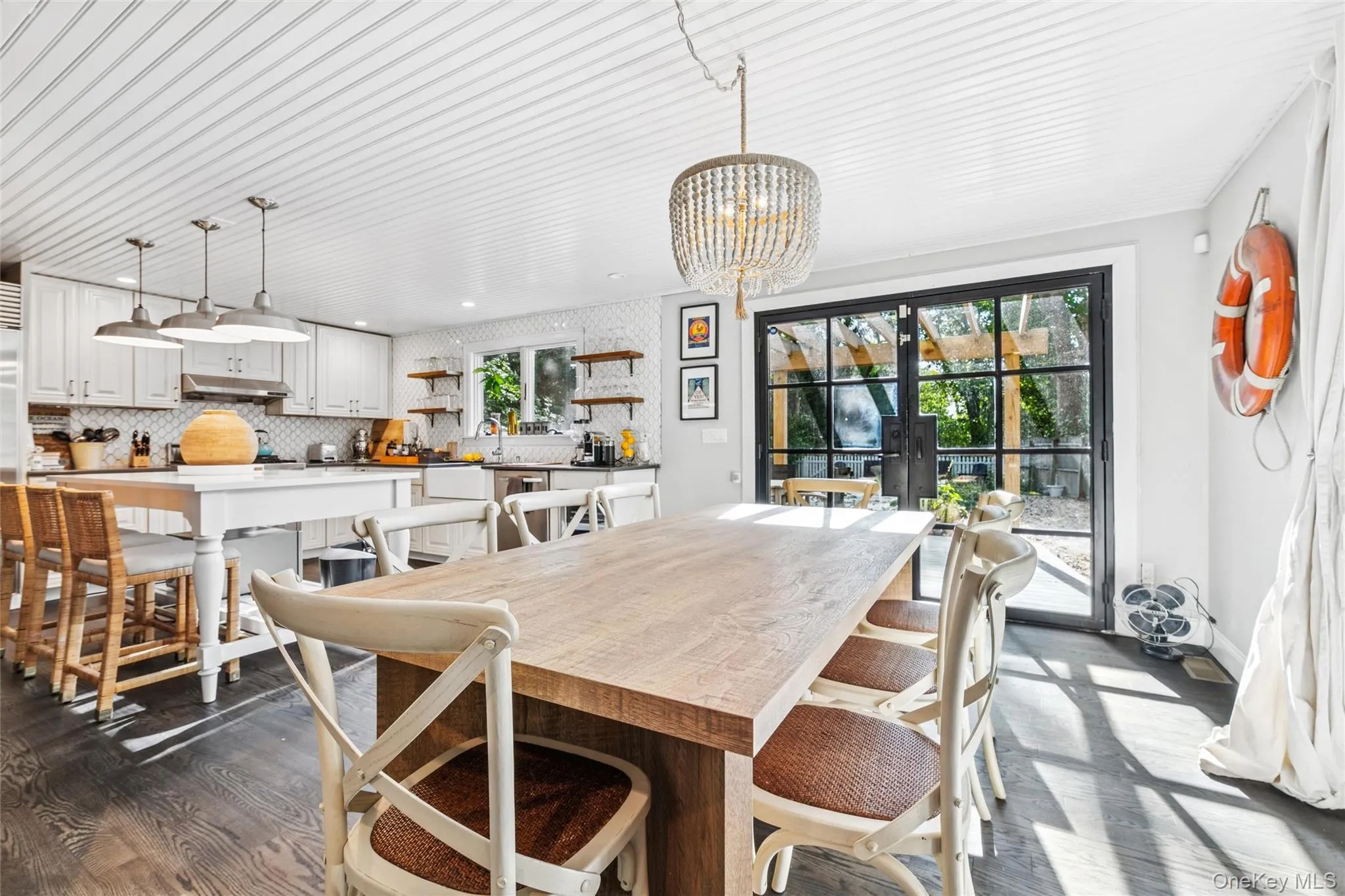 Dining room with dark wood-style flooring, french doors, and a chandelier Dining room with dark wood-style flooring, french doors, and a chandelier