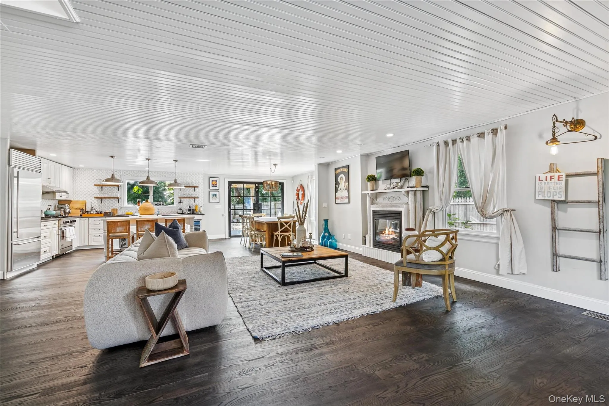 Living room with a glass covered fireplace and wood finished floors Living room with a glass covered fireplace and wood finished floors