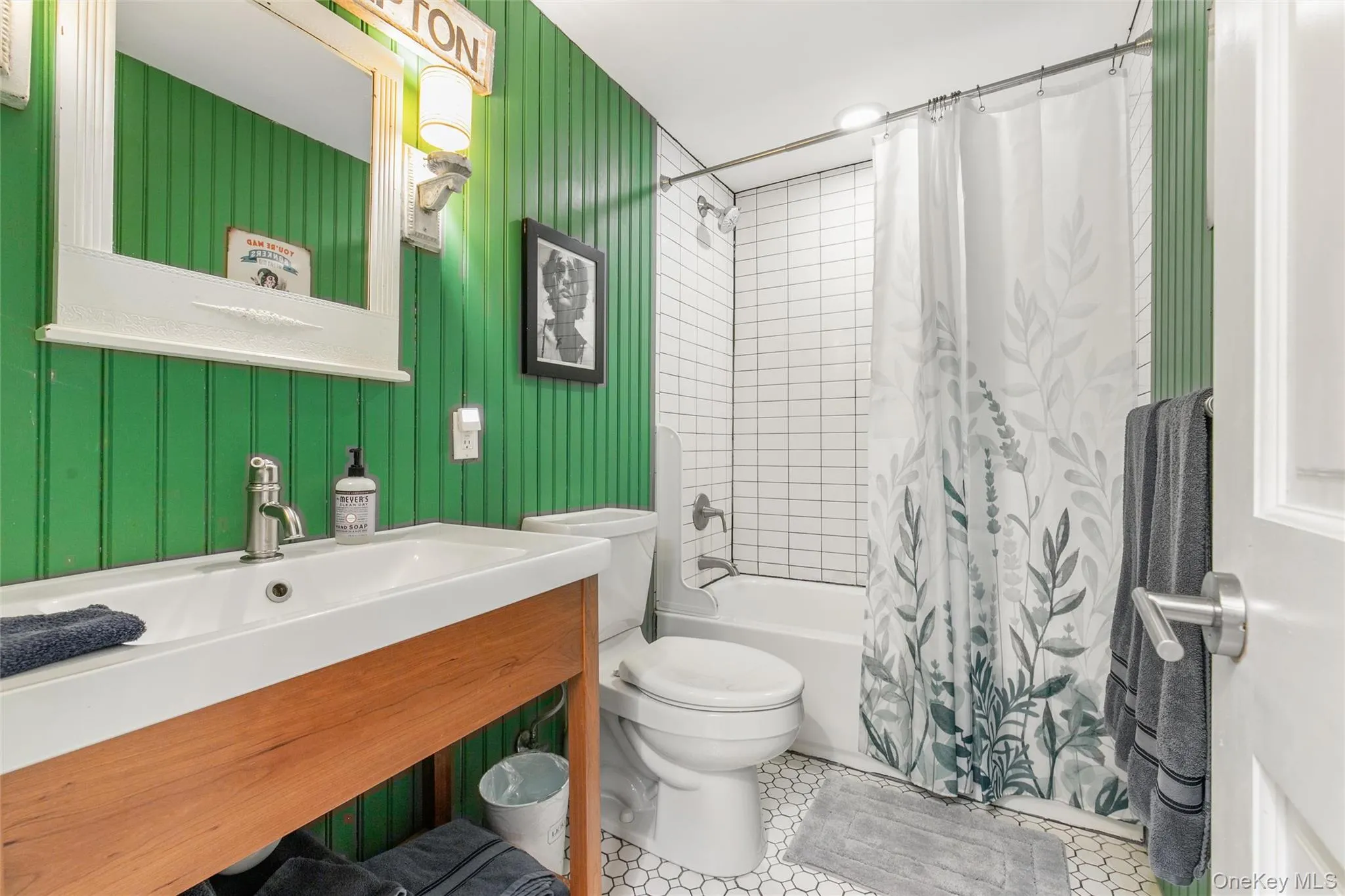 Bathroom with shower / tub combo, vanity, and light tile patterned floors Bathroom with shower / tub combo, vanity, and light tile patterned floors