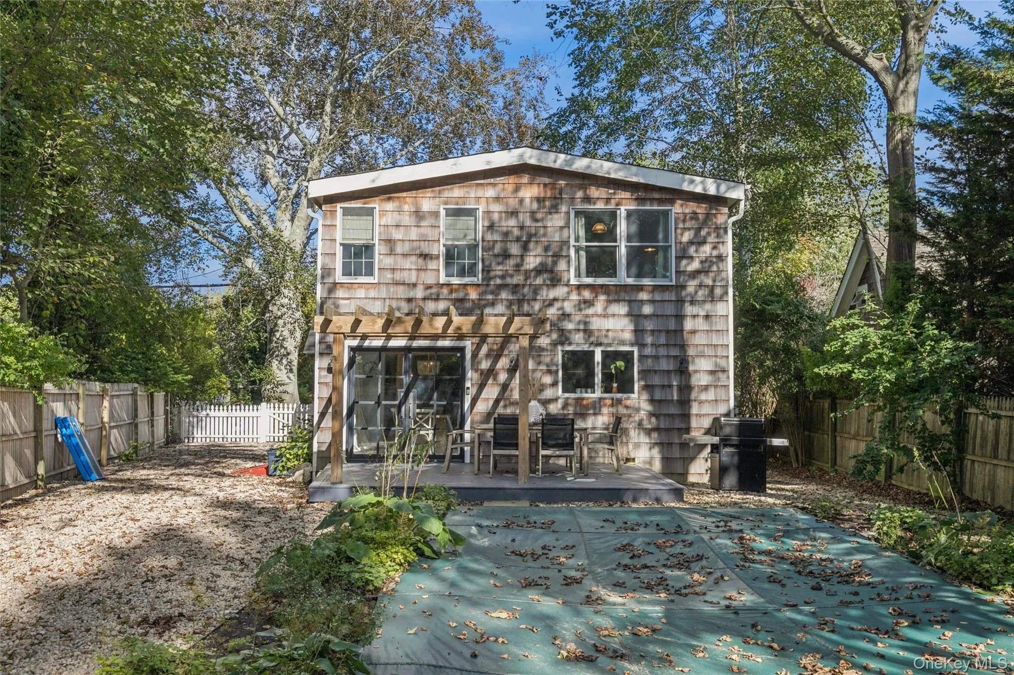 Rear view of property featuring a fenced backyard and a wooden deck Rear view of property featuring a fenced backyard and a wooden deck