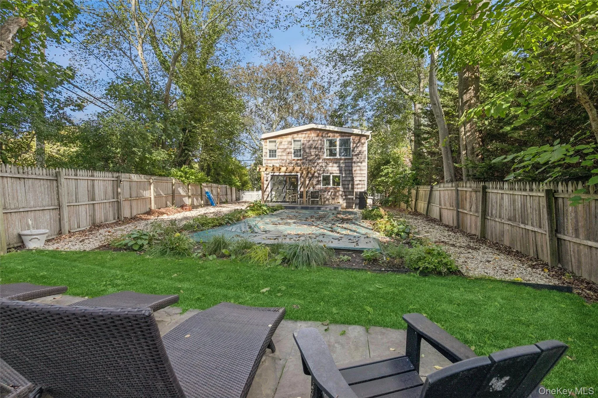 Fenced backyard with a patio area and a pool Fenced backyard with a patio area and a pool