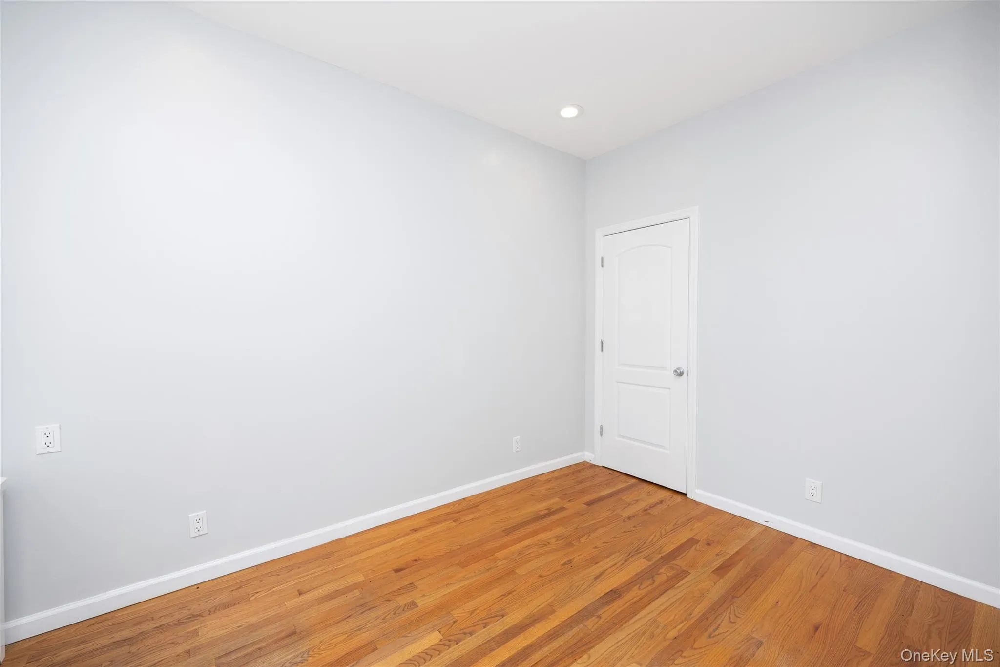 Spare room with wood finished floors and recessed lighting Spare room with wood finished floors and recessed lighting