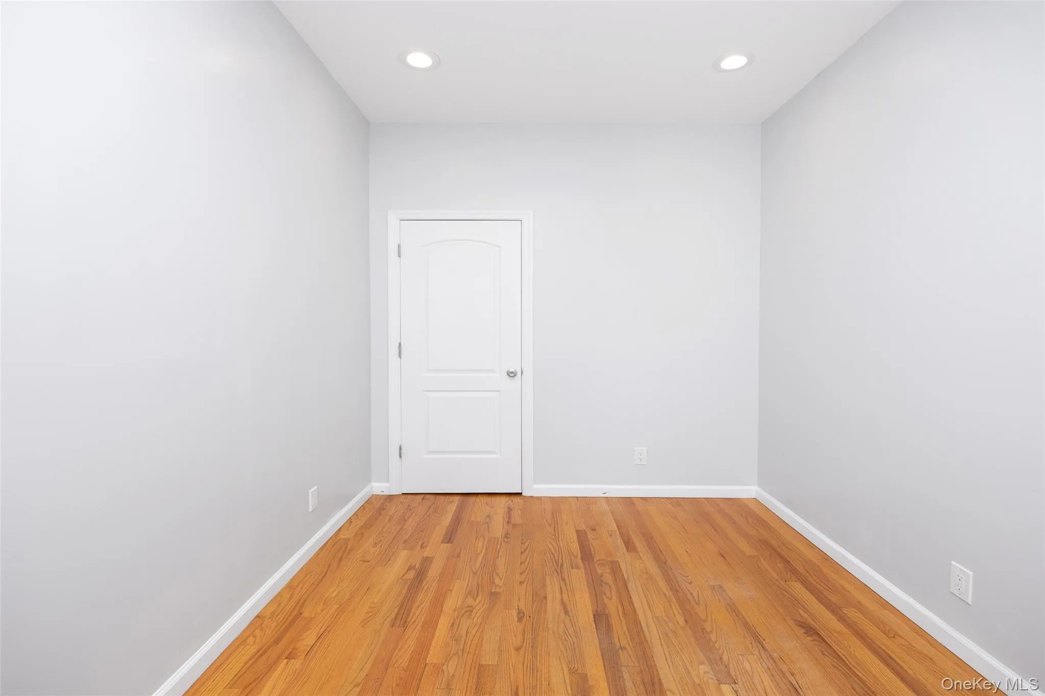 Empty room featuring light wood finished floors and recessed lighting Empty room featuring light wood finished floors and recessed lighting