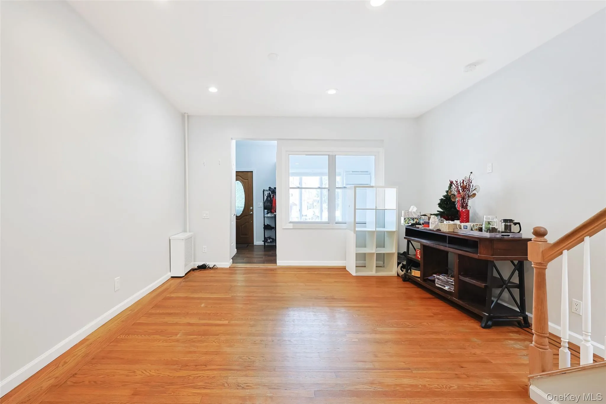 Empty room featuring stairs, light wood finished floors, and recessed lighting Empty room featuring stairs, light wood finished floors, and recessed lighting