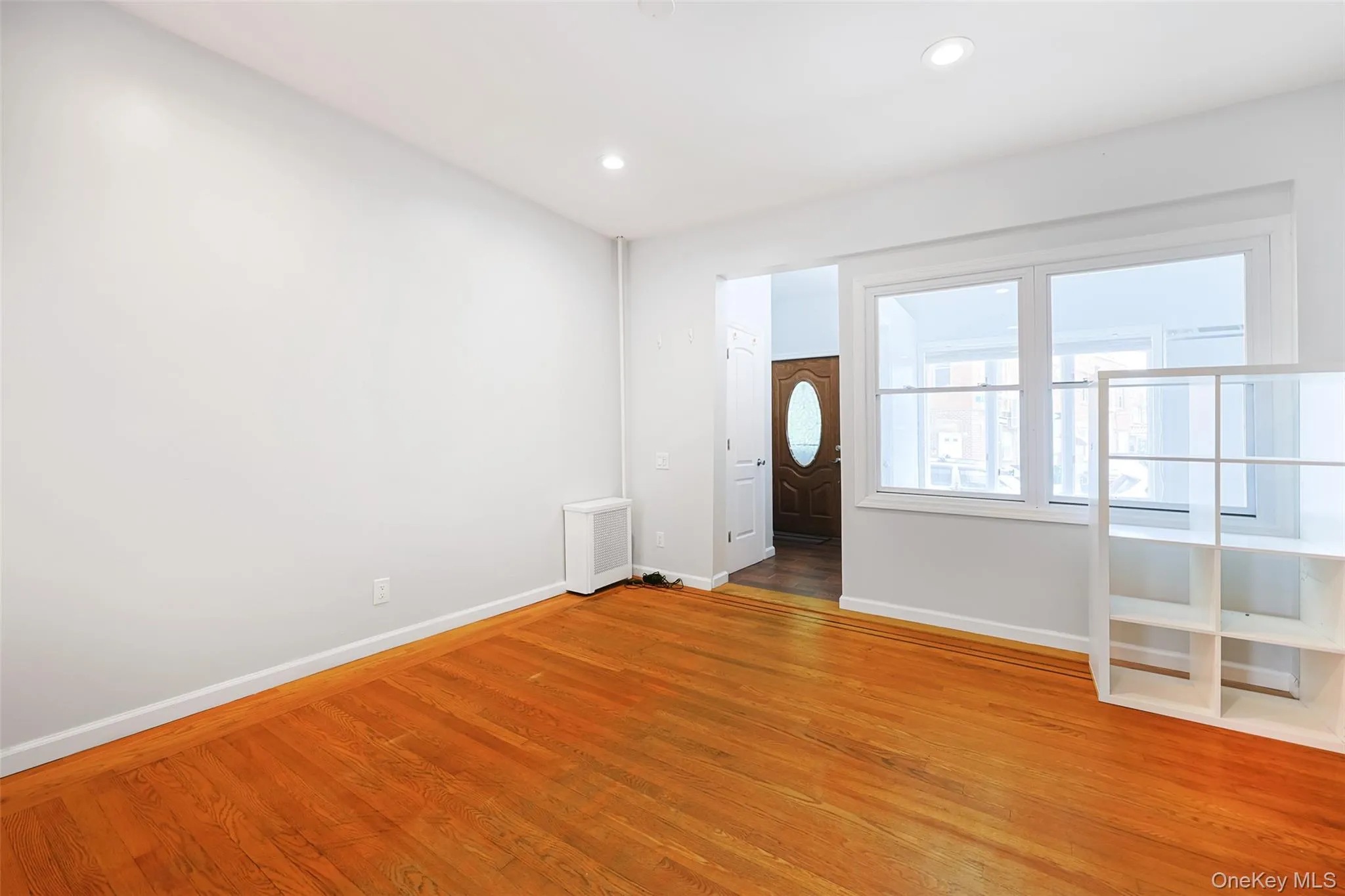 Entrance foyer featuring light wood-style floors, recessed lighting, and radiator Entrance foyer featuring light wood-style floors, recessed lighting, and radiator