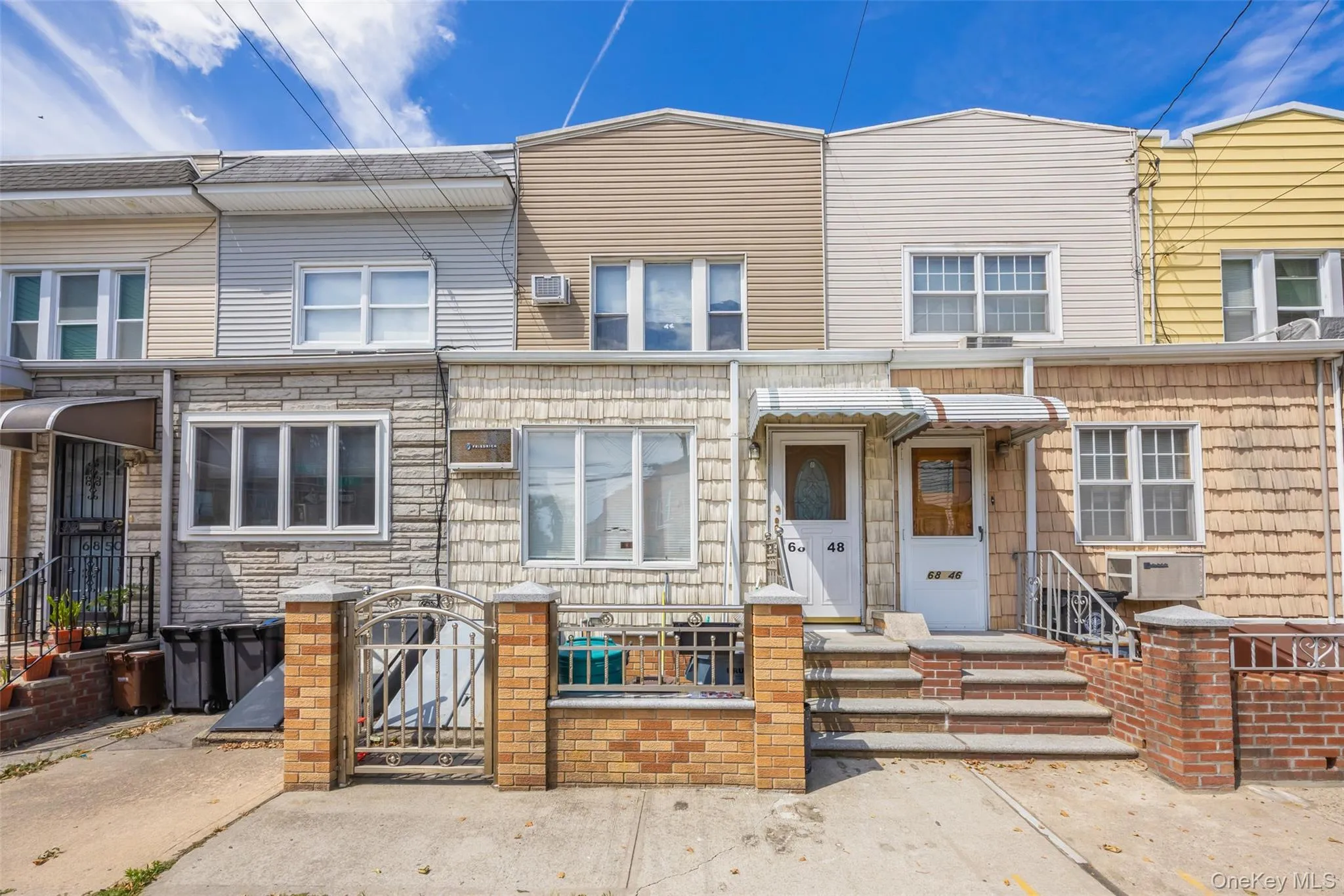 Traditional-style home featuring a gate and a fenced front yard Traditional-style home featuring a gate and a fenced front yard