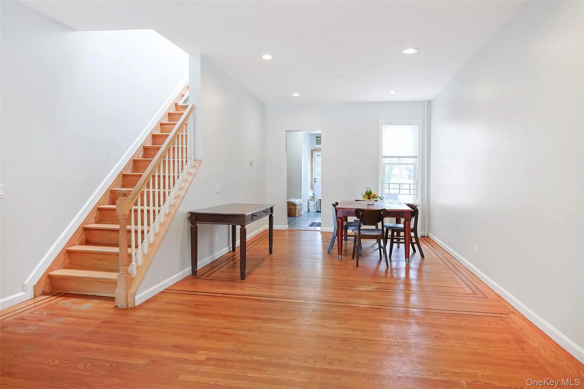 Dining area with recessed lighting, light wood-type flooring, and stairs Dining area with recessed lighting, light wood-type flooring, and stairs