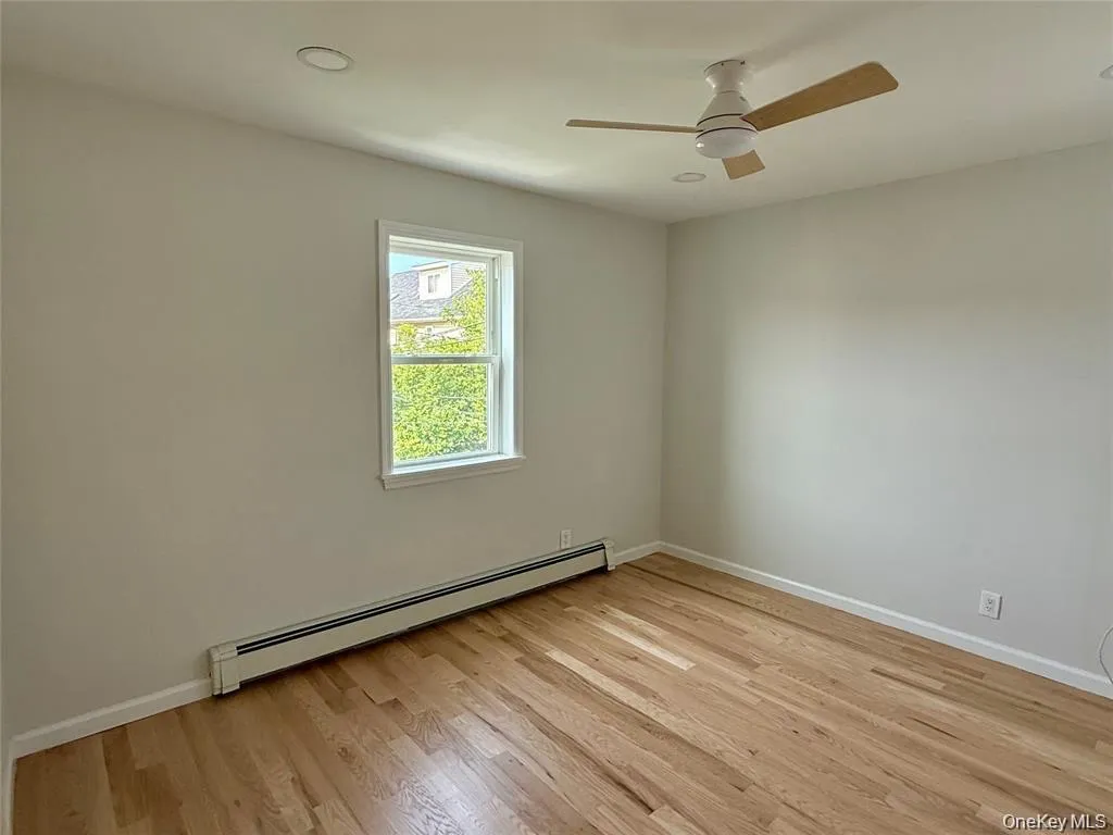 Spare room with baseboard heating, light wood-type flooring, a ceiling fan, and recessed lighting Spare room with baseboard heating, light wood-type flooring, a ceiling fan, and recessed lighting