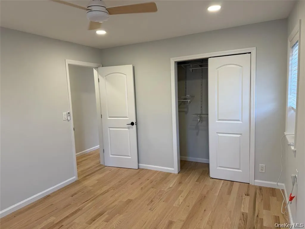 Unfurnished bedroom with light wood-type flooring, a ceiling fan, a closet, and recessed lighting Unfurnished bedroom with light wood-type flooring, a ceiling fan, a closet, and recessed lighting