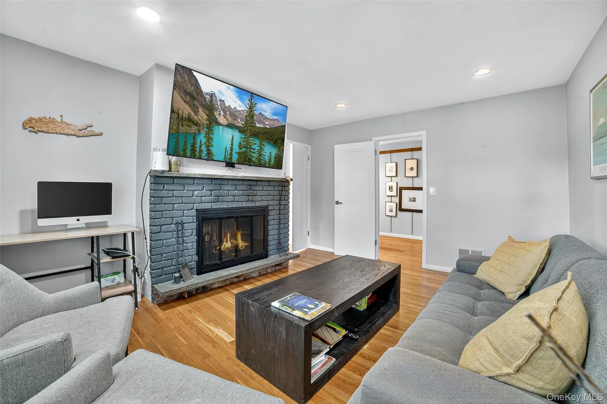 Lower Level  room with light wood finished floors, recessed lighting, and a fireplace Lower Level  room with light wood finished floors, recessed lighting, and a fireplace