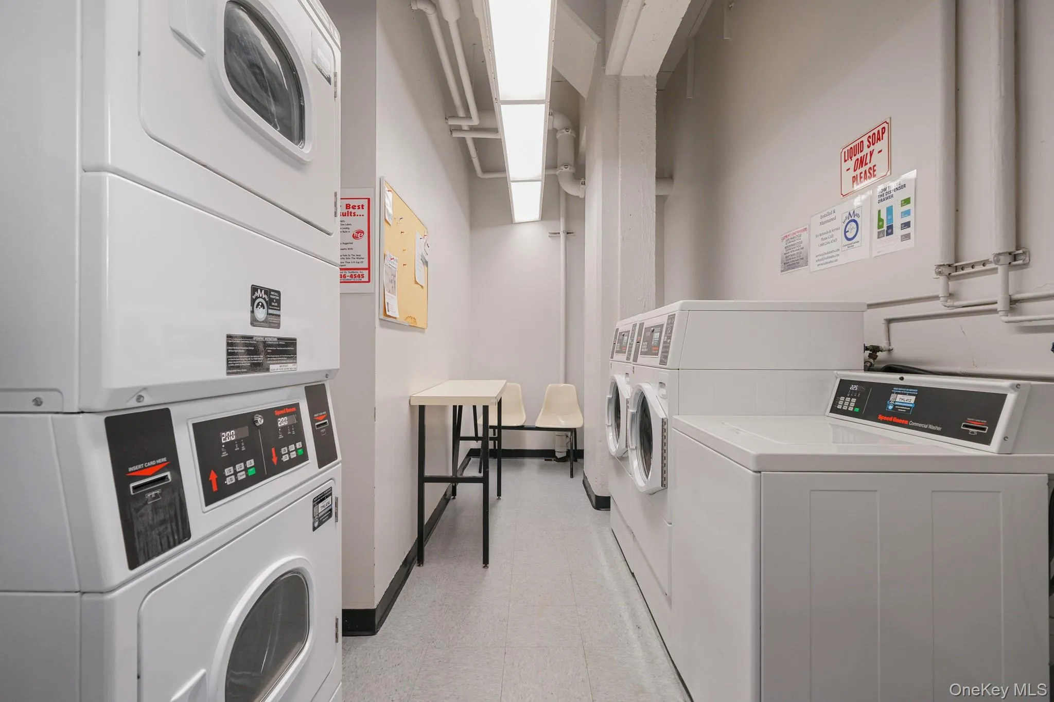 Community laundry featuring stacked washing machine and dryer Community laundry featuring stacked washing machine and dryer