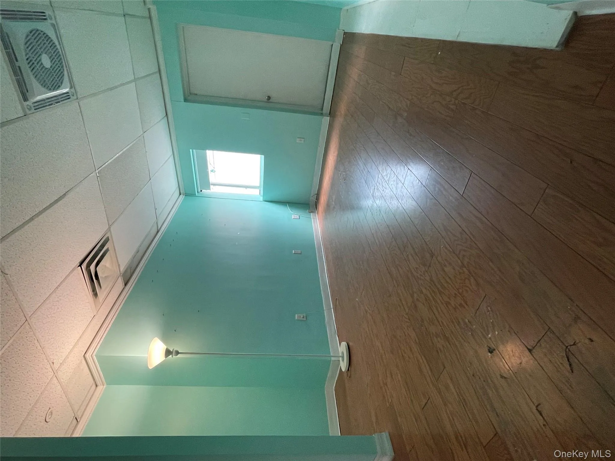 Unfurnished room with dark wood finished floors and a paneled ceiling Unfurnished room with dark wood finished floors and a paneled ceiling