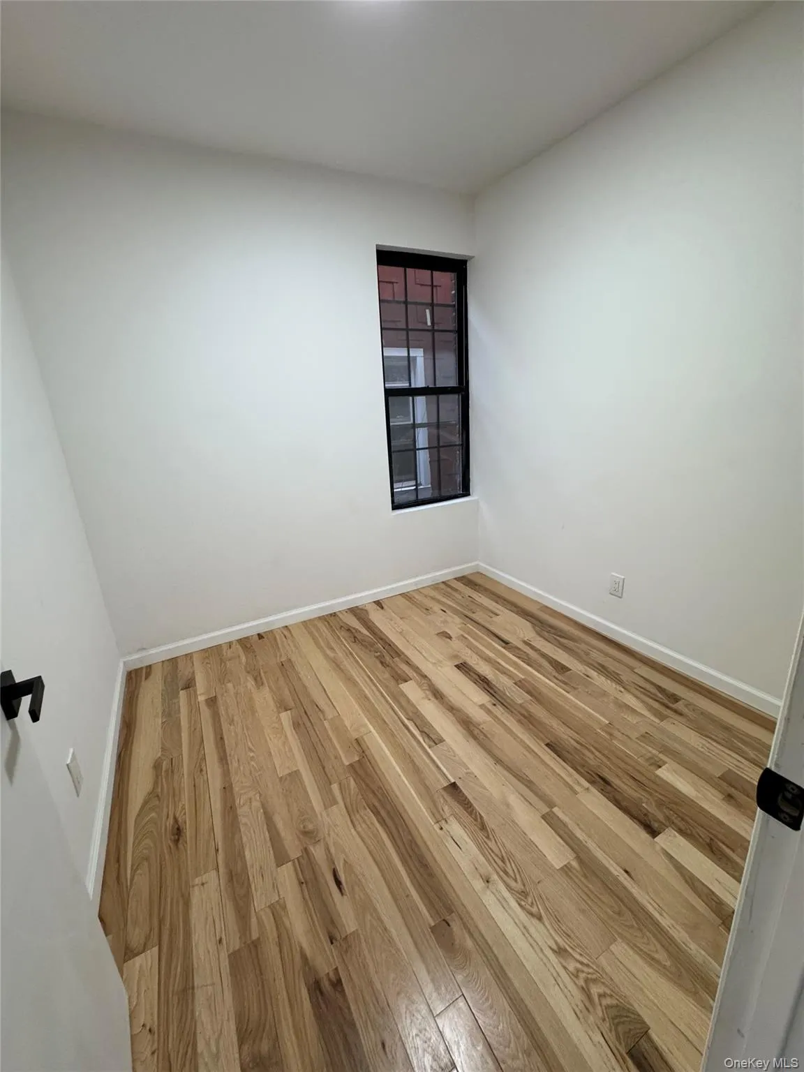 Unfurnished room featuring hardwood / wood-style floors and baseboards Unfurnished room featuring hardwood / wood-style floors and baseboards