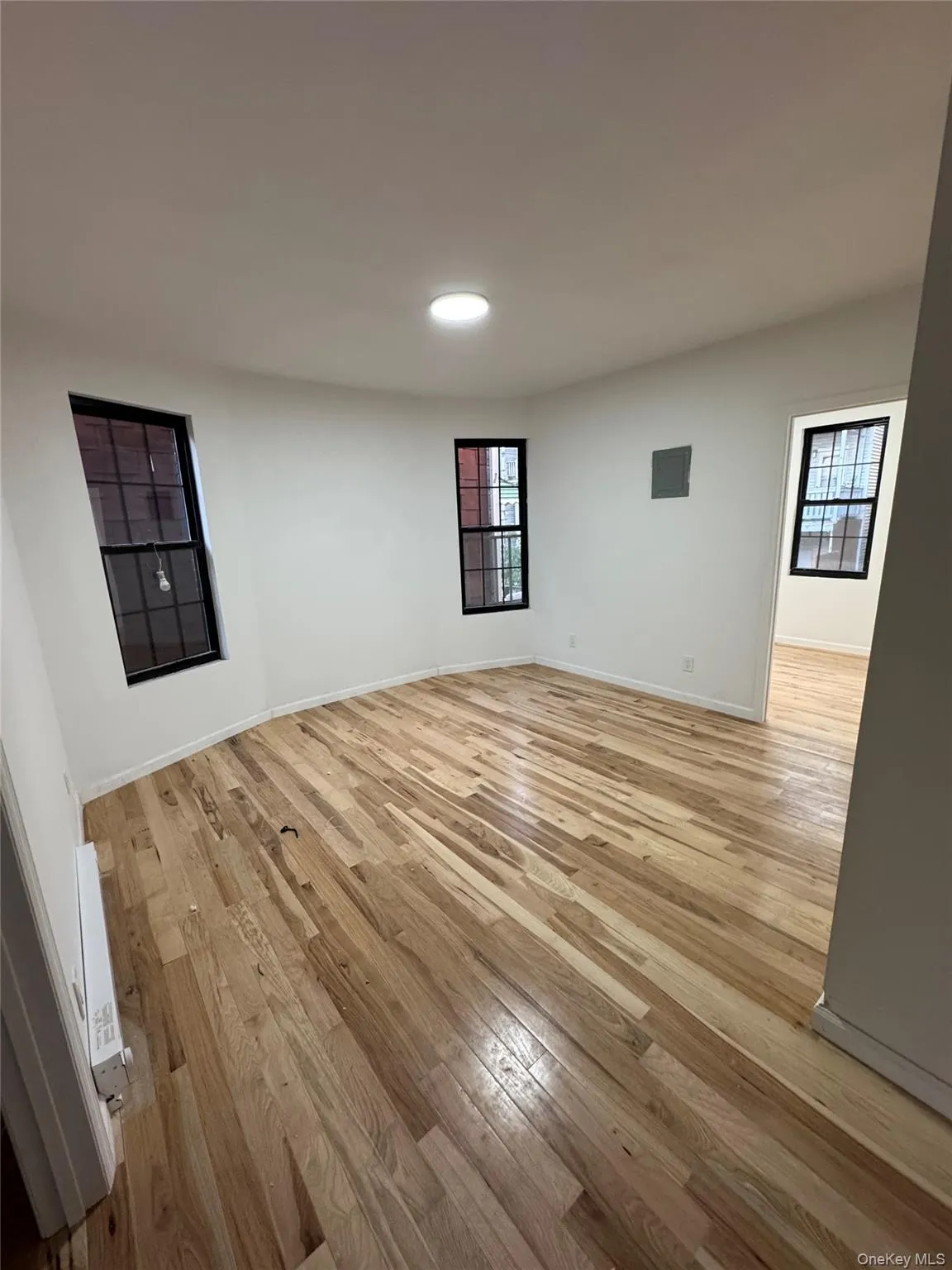 Spare room featuring light wood finished floors and baseboards Spare room featuring light wood finished floors and baseboards