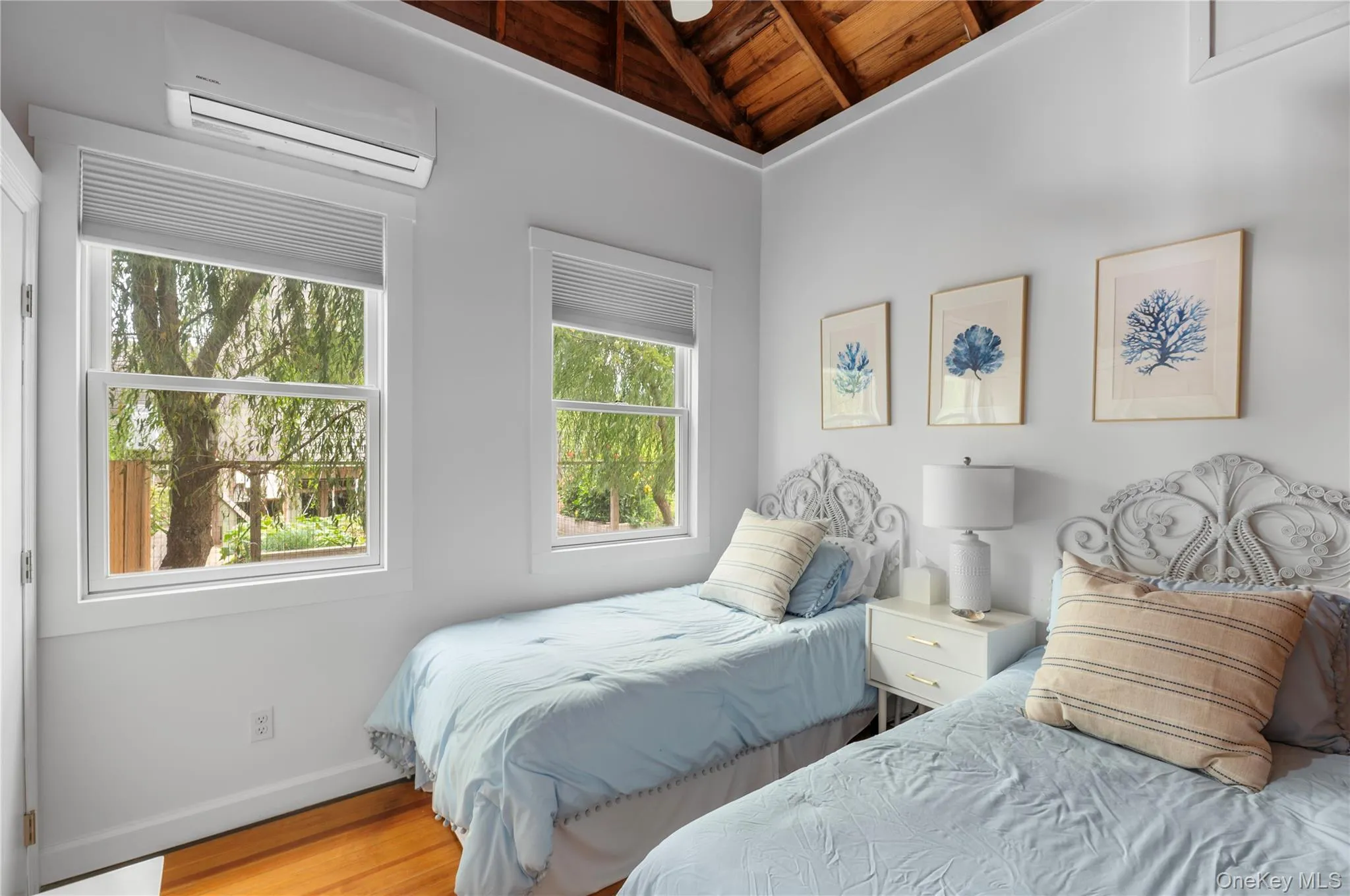 Bedroom featuring wooden ceiling, a wall mounted air conditioner, wood finished floors, and lofted ceiling Bedroom featuring wooden ceiling, a wall mounted air conditioner, wood finished floors, and lofted ceiling