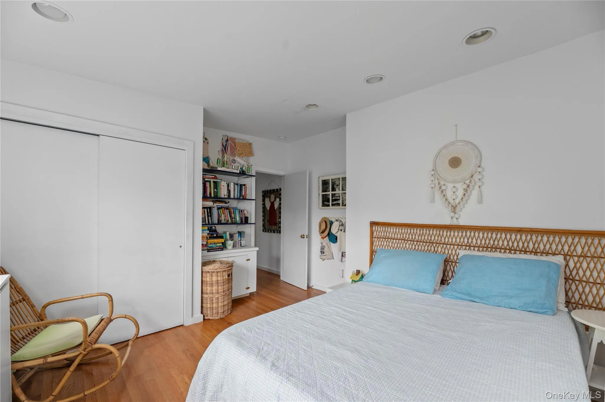 Bedroom with light wood finished floors, a closet, and recessed lighting Bedroom with light wood finished floors, a closet, and recessed lighting