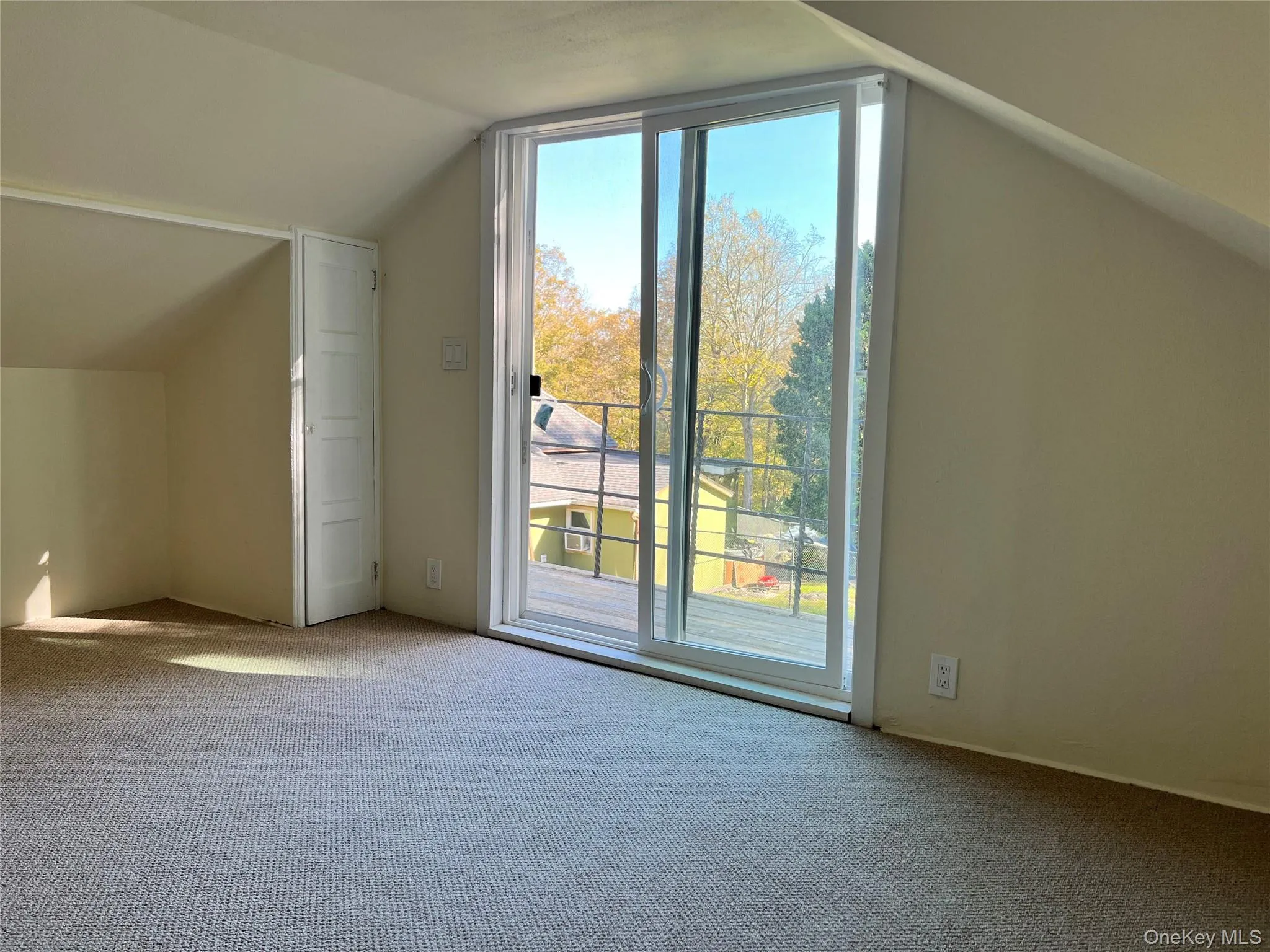Bonus room featuring lofted ceiling and carpet flooring Bonus room featuring lofted ceiling and carpet flooring