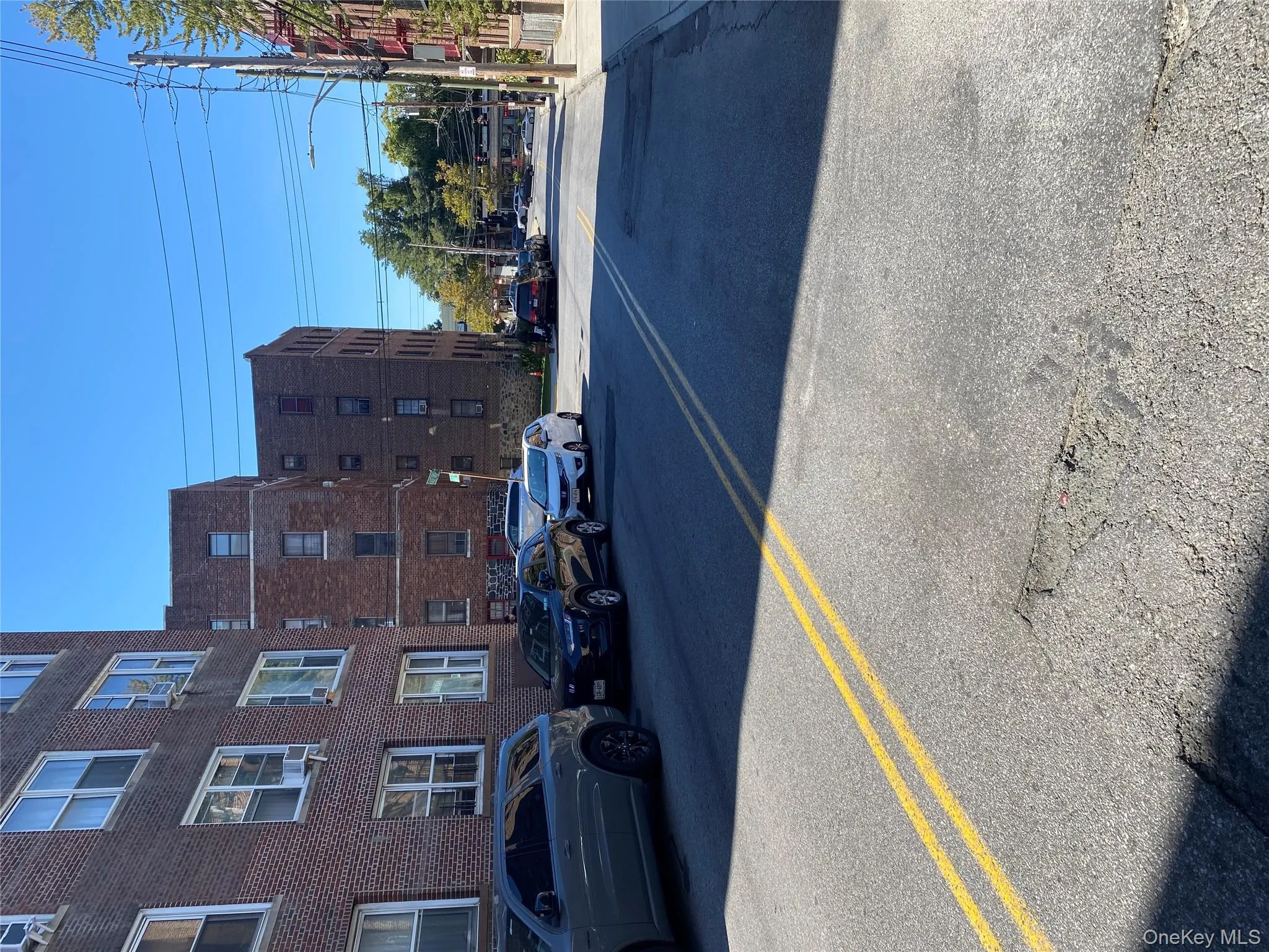 View of asphalt street with street lights and sidewalks View of asphalt street with street lights and sidewalks
