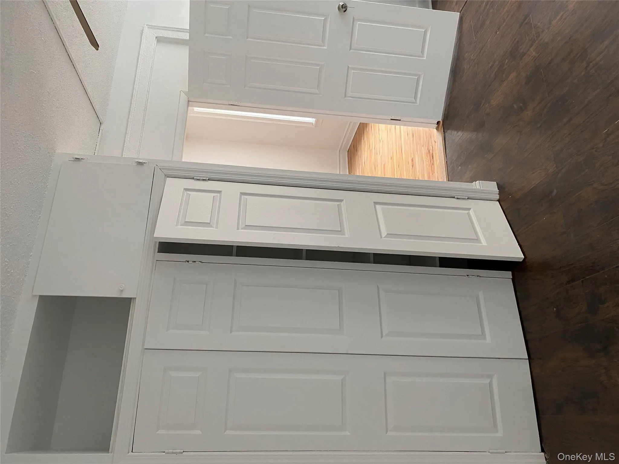 Unfurnished bedroom with dark wood-type flooring, a closet, and a textured ceiling Unfurnished bedroom with dark wood-type flooring, a closet, and a textured ceiling