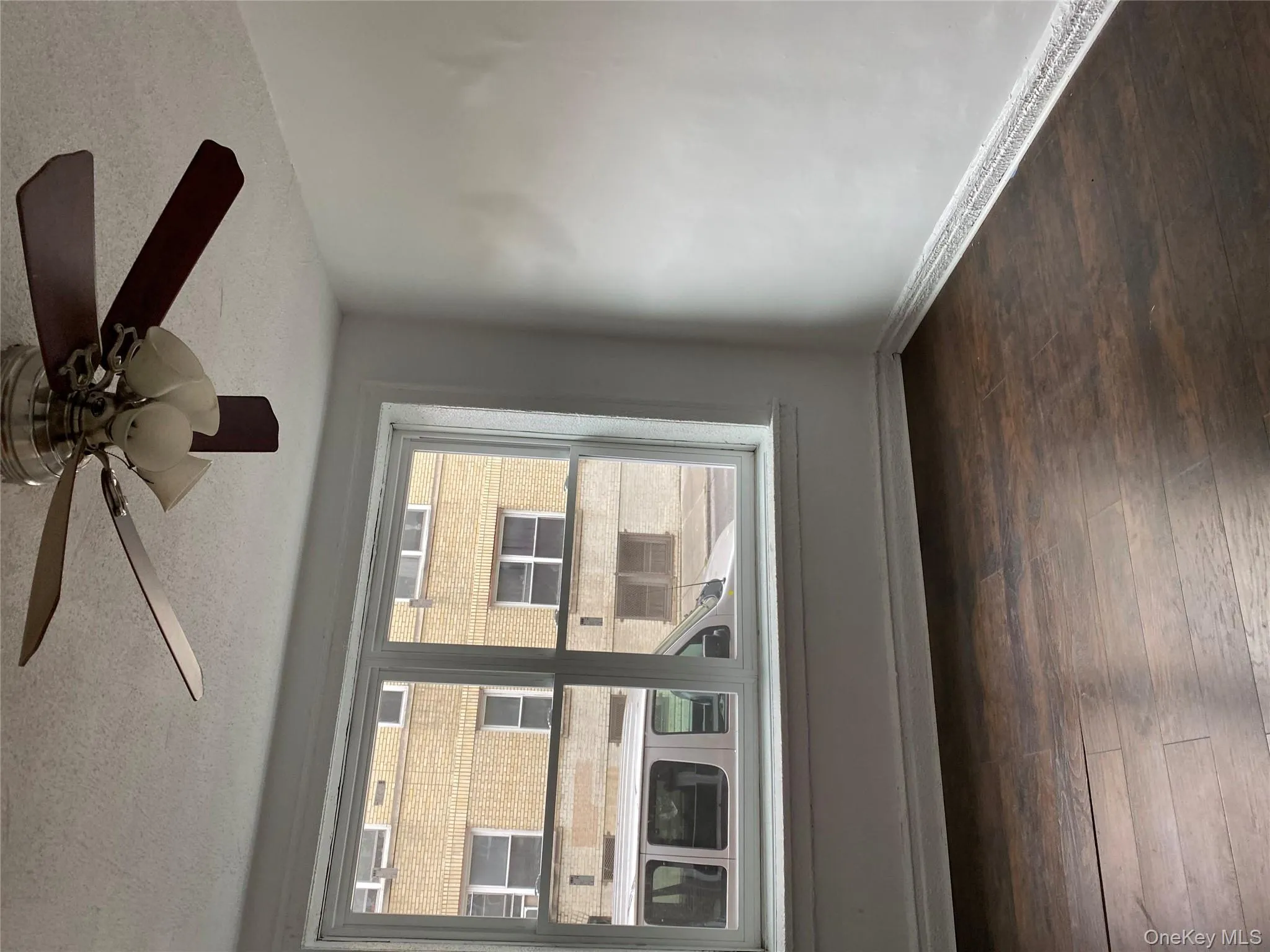 Unfurnished room featuring a textured ceiling, dark wood finished floors, and ceiling fan Unfurnished room featuring a textured ceiling, dark wood finished floors, and ceiling fan