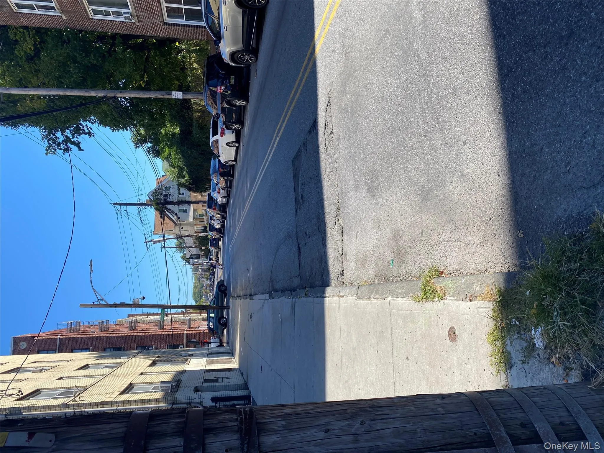View of asphalt road featuring street lighting, sidewalks, and curbs View of asphalt road featuring street lighting, sidewalks, and curbs