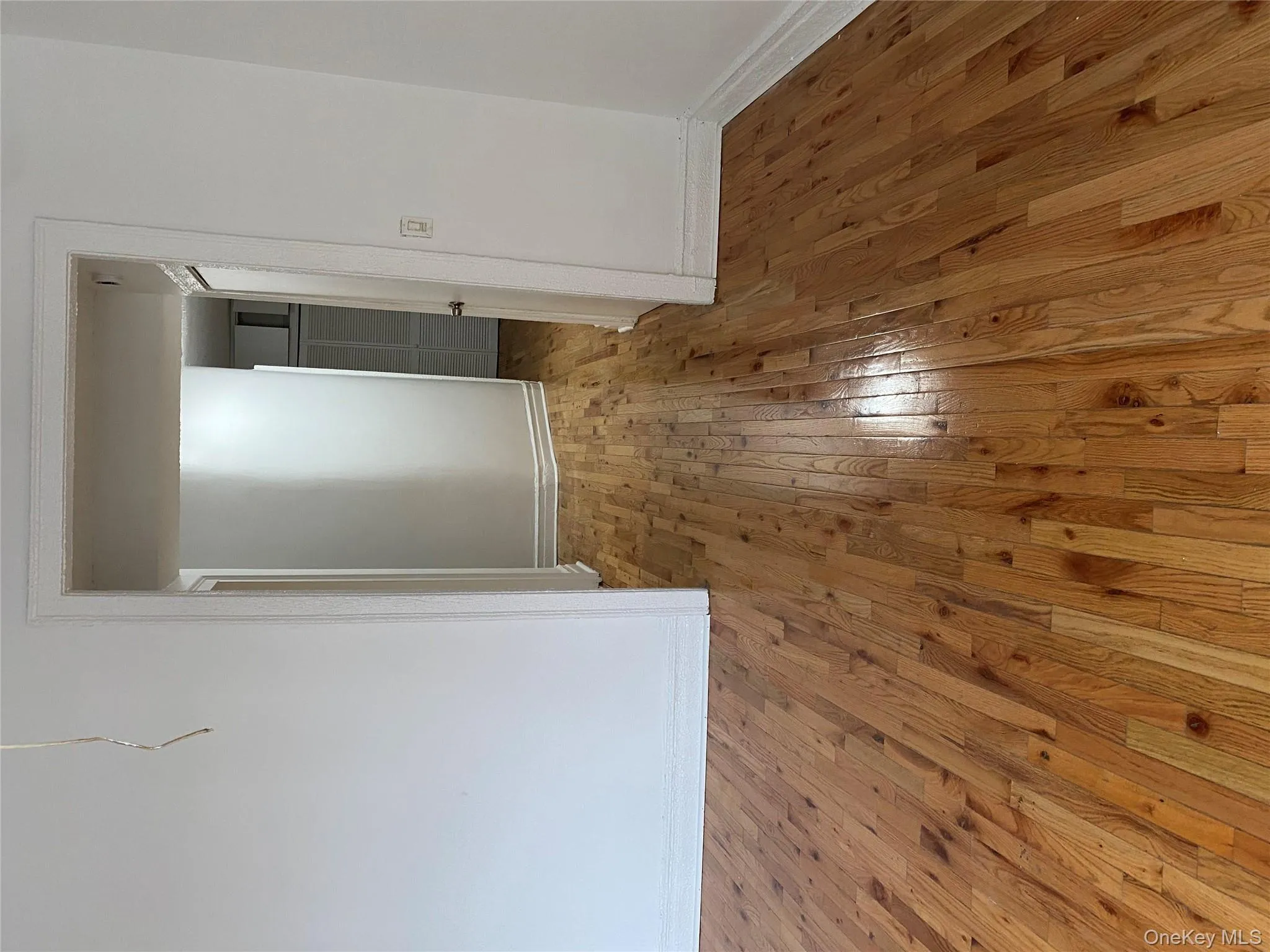 Empty room featuring light wood-type flooring and baseboards Empty room featuring light wood-type flooring and baseboards
