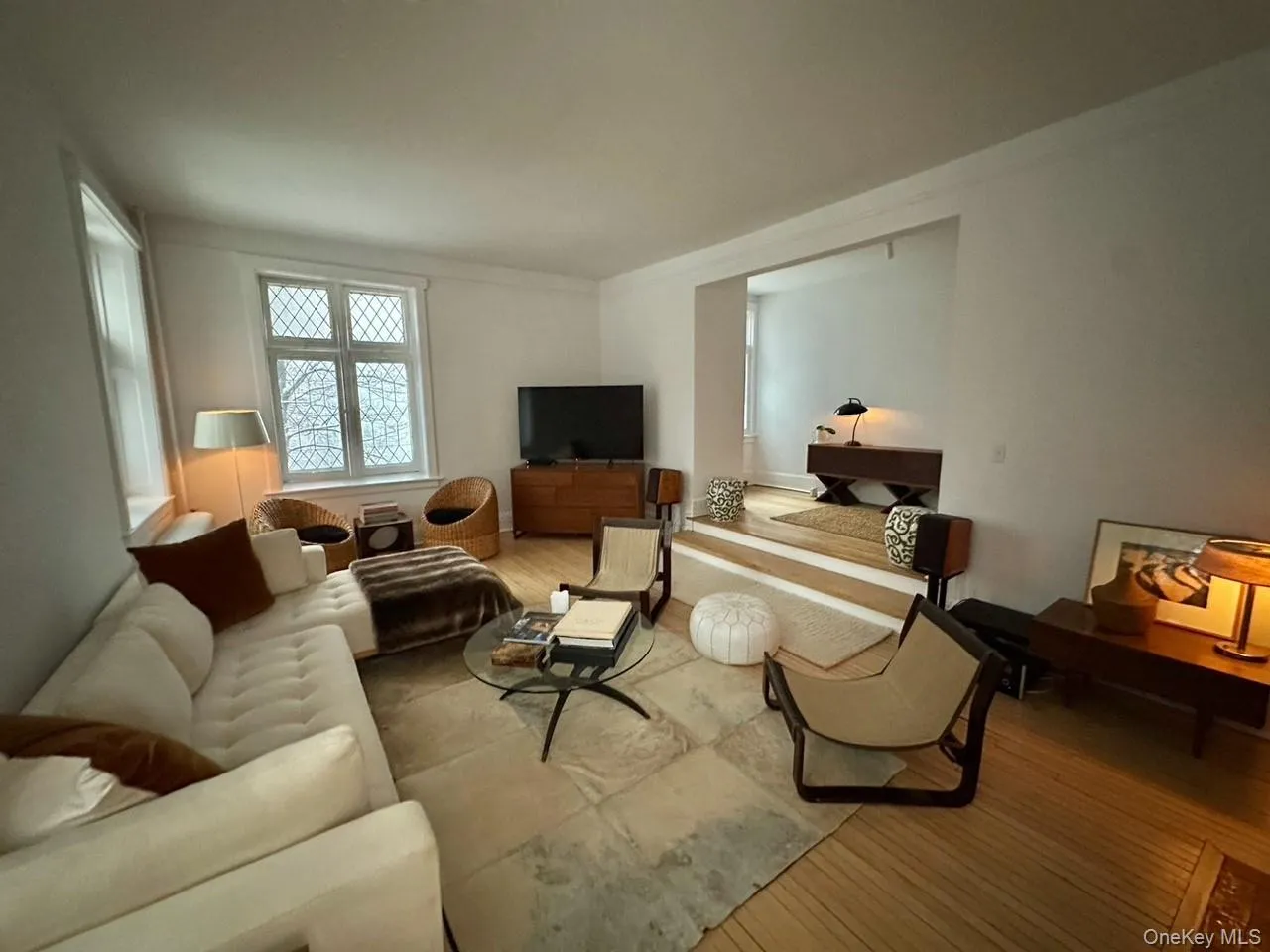 Living room featuring wood-type flooring and crown molding Living room featuring wood-type flooring and crown molding