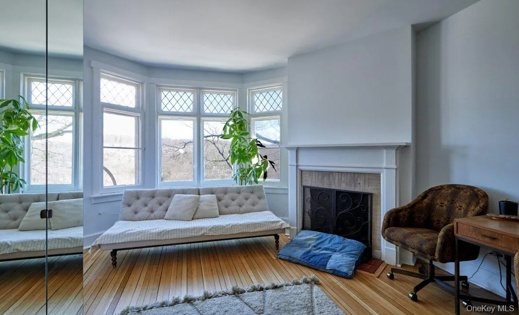 Living area with wood-type flooring and a fireplace Living area with wood-type flooring and a fireplace