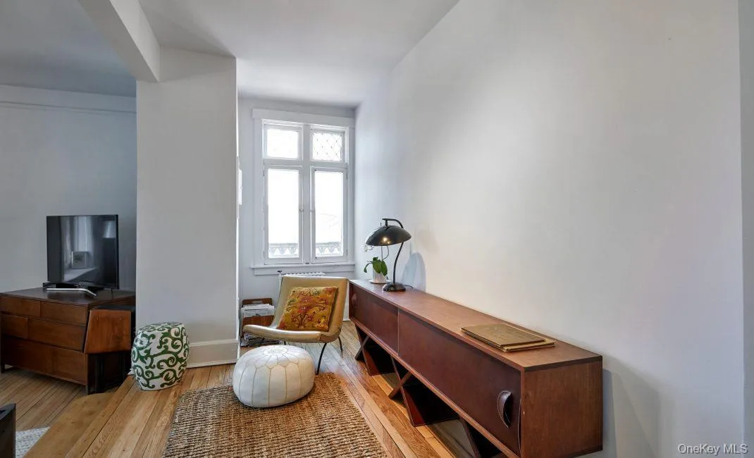 Sitting room with light wood-style flooring and baseboards Sitting room with light wood-style flooring and baseboards