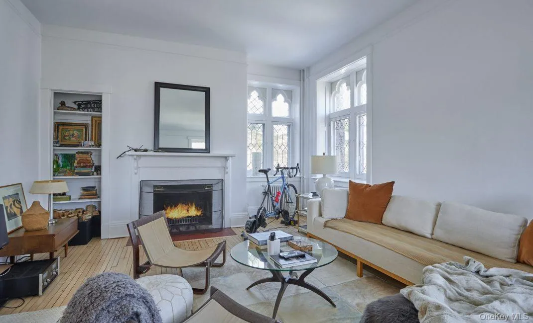 Living room with wood finished floors and a fireplace with flush hearth Living room with wood finished floors and a fireplace with flush hearth
