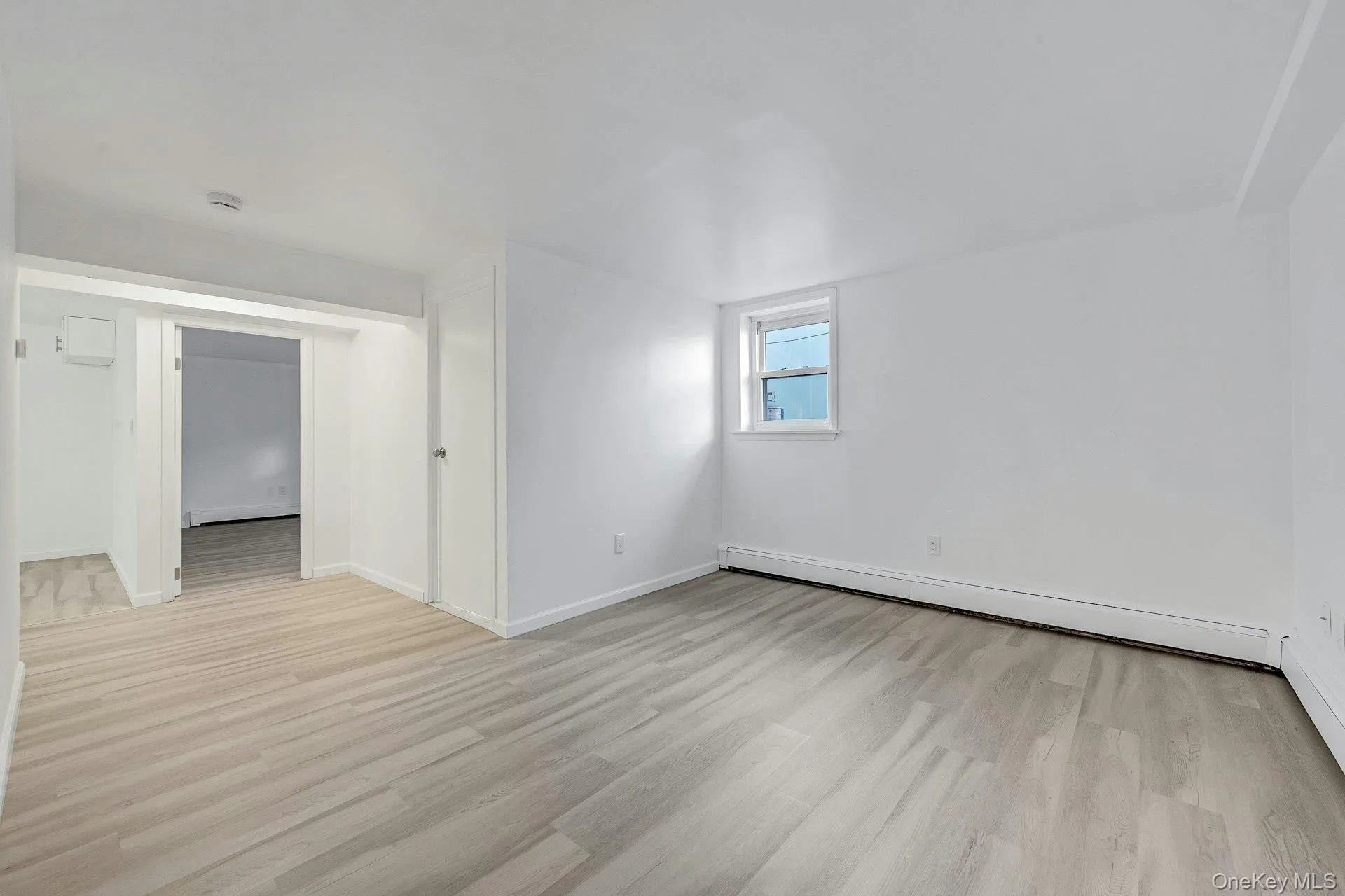 Bonus room with light wood-type flooring and a baseboard radiator Bonus room with light wood-type flooring and a baseboard radiator