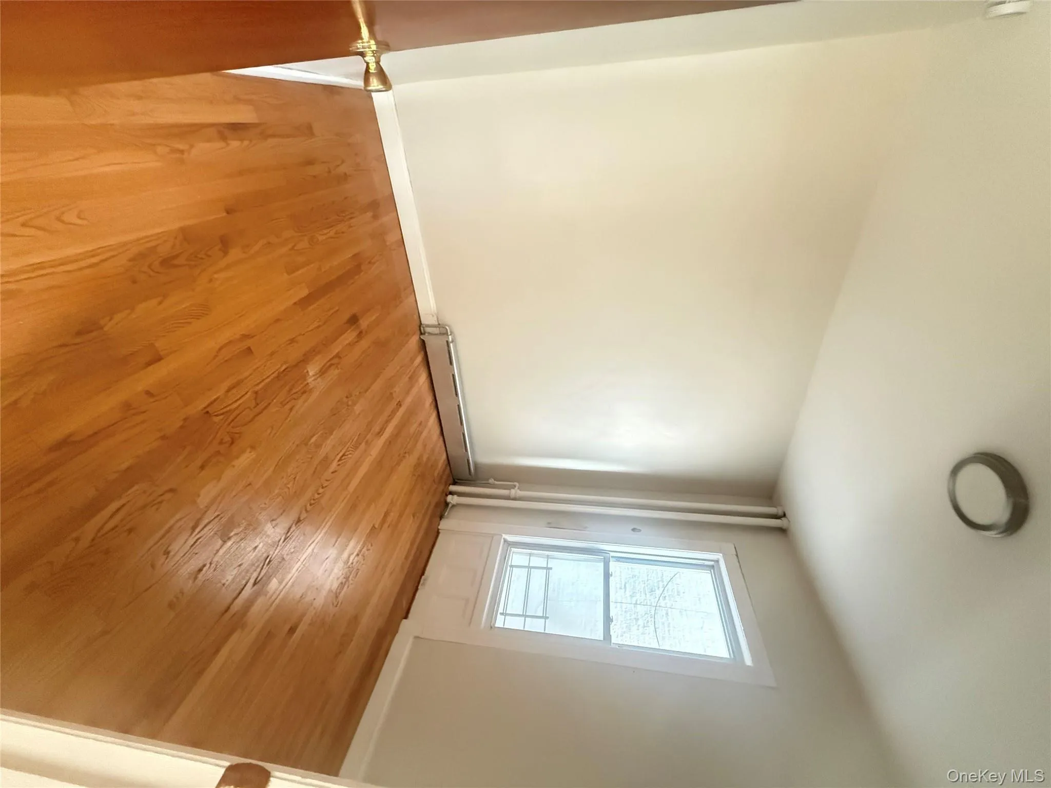 Unfurnished room featuring light wood-type flooring and a baseboard heating unit Unfurnished room featuring light wood-type flooring and a baseboard heating unit