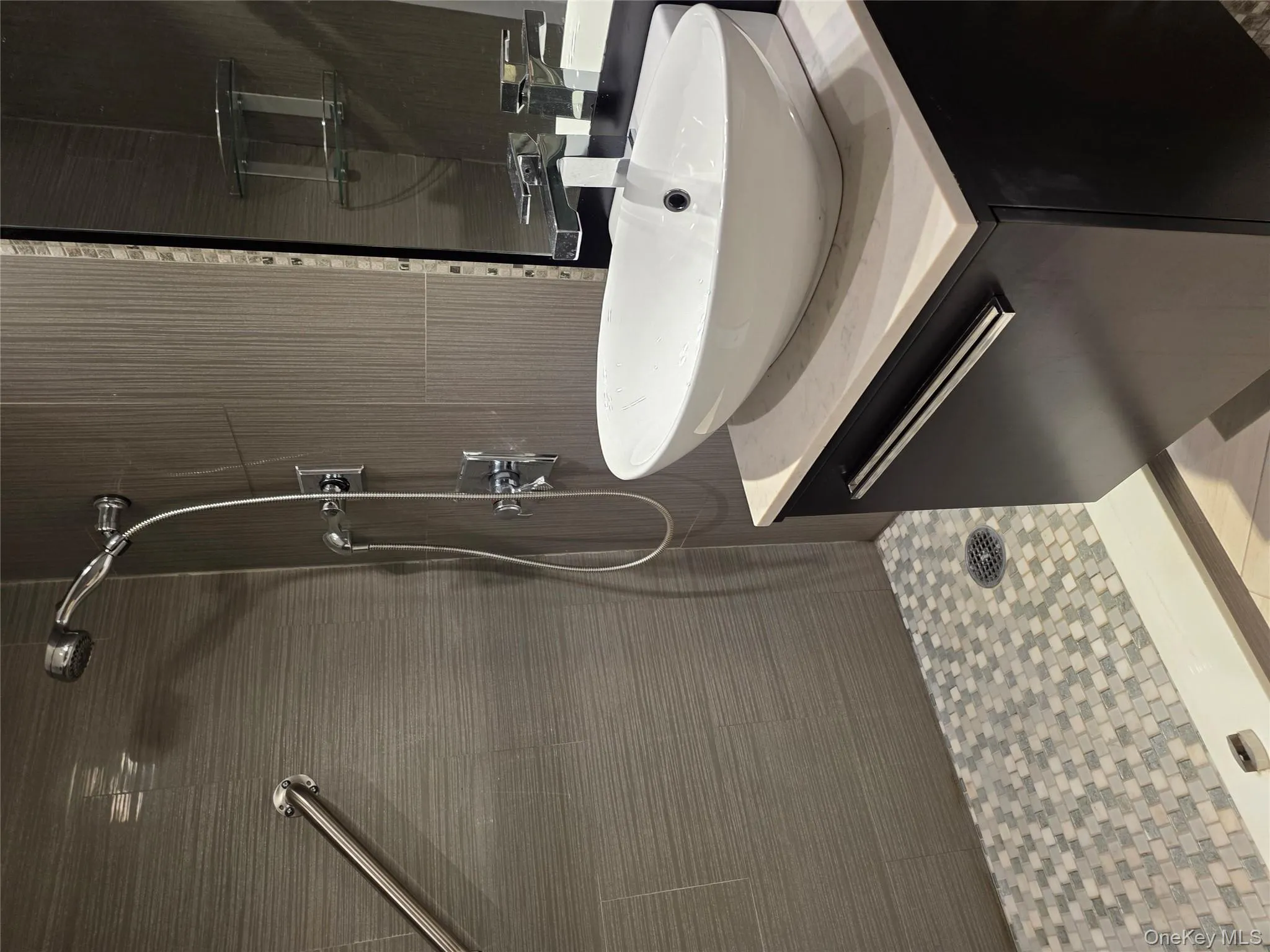 Bathroom with vanity and a shower stall Bathroom with vanity and a shower stall