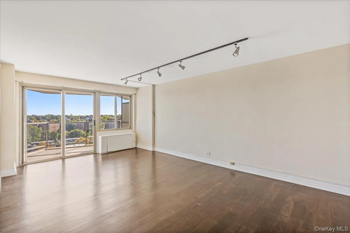 Spare room with rail lighting and wood finished floors Spare room with rail lighting and wood finished floors