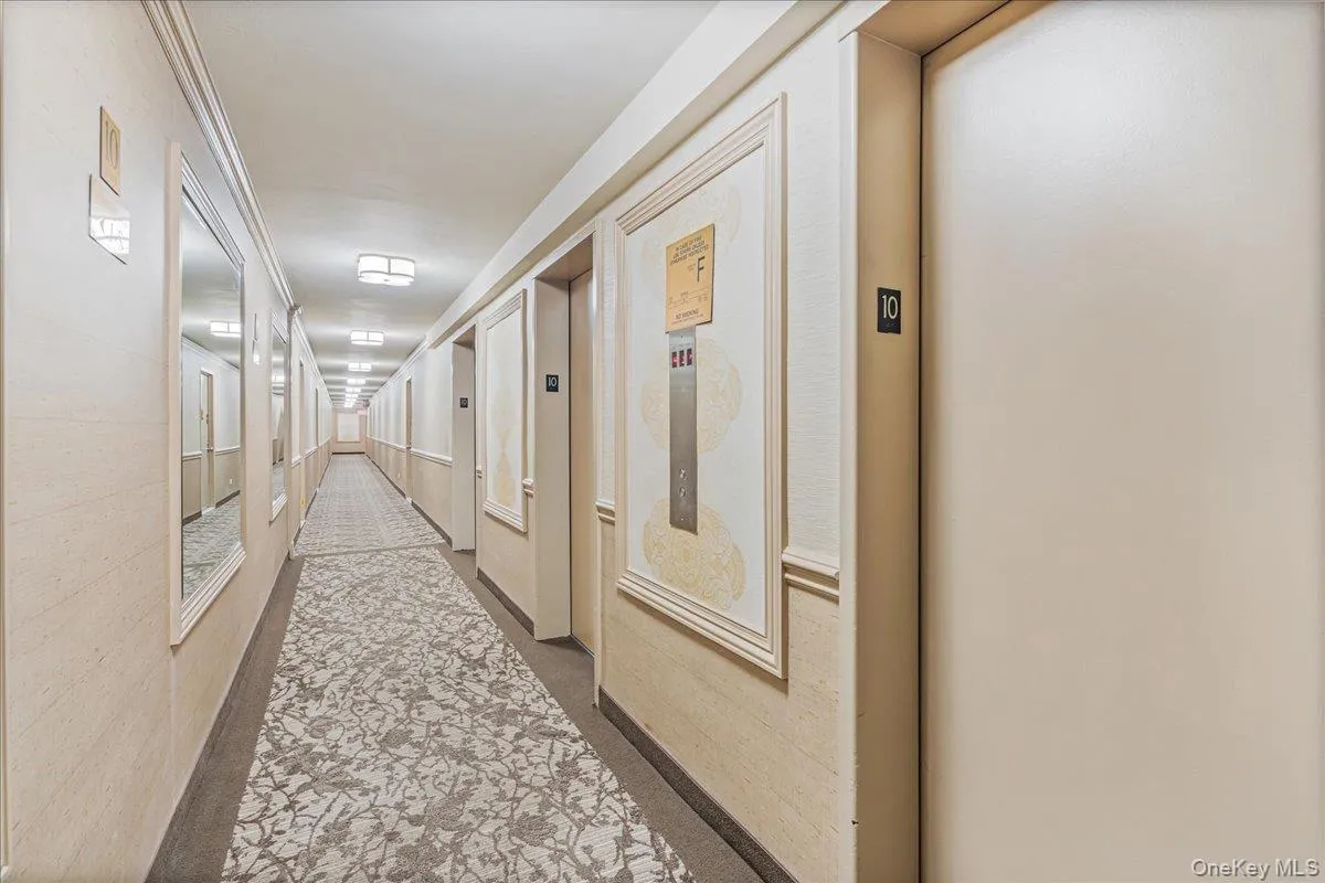 Hallway featuring elevator and carpet Hallway featuring elevator and carpet