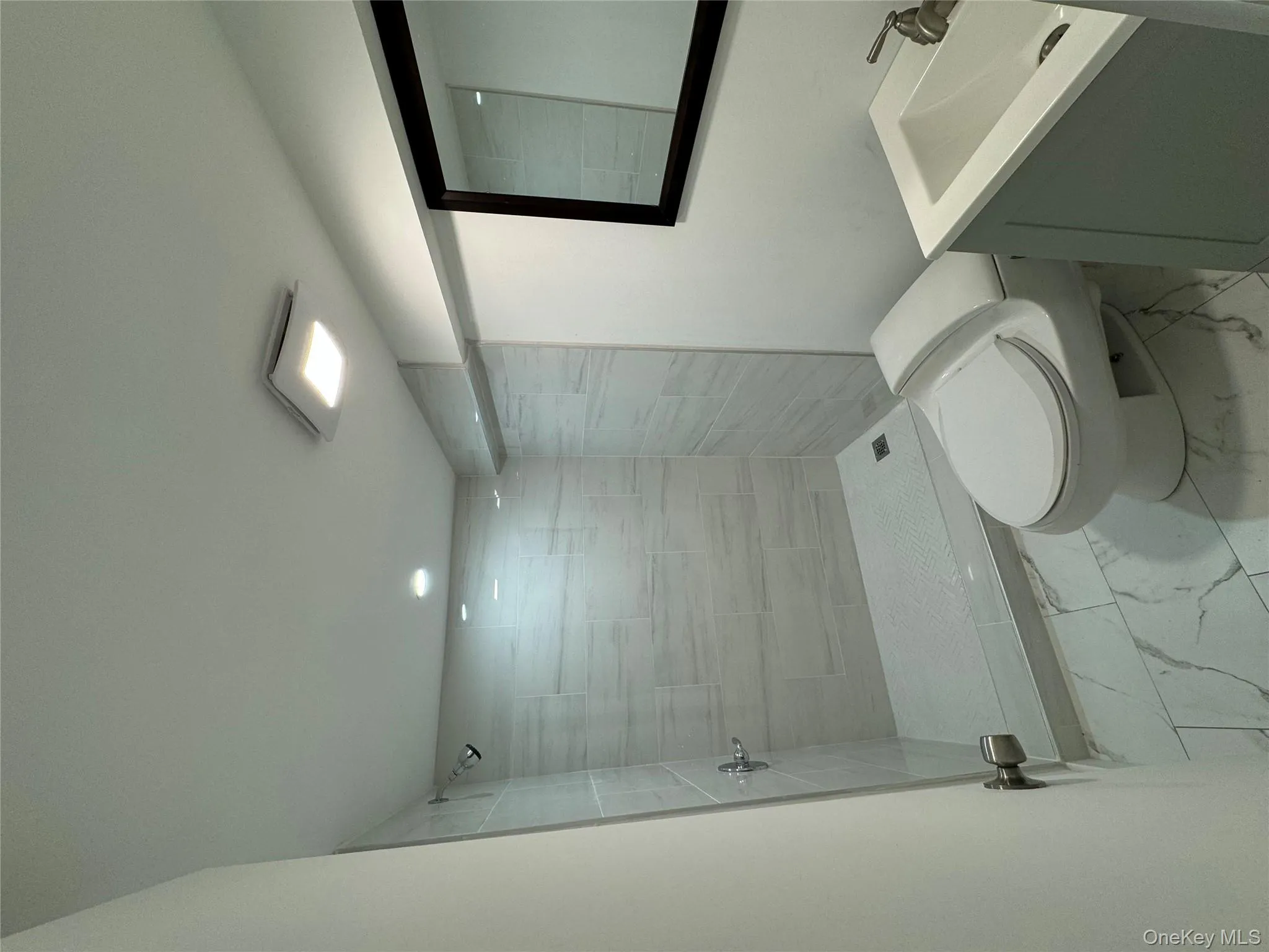 Bathroom with vanity, a stall shower, light marble finish flooring, and recessed lighting Bathroom with vanity, a stall shower, light marble finish flooring, and recessed lighting