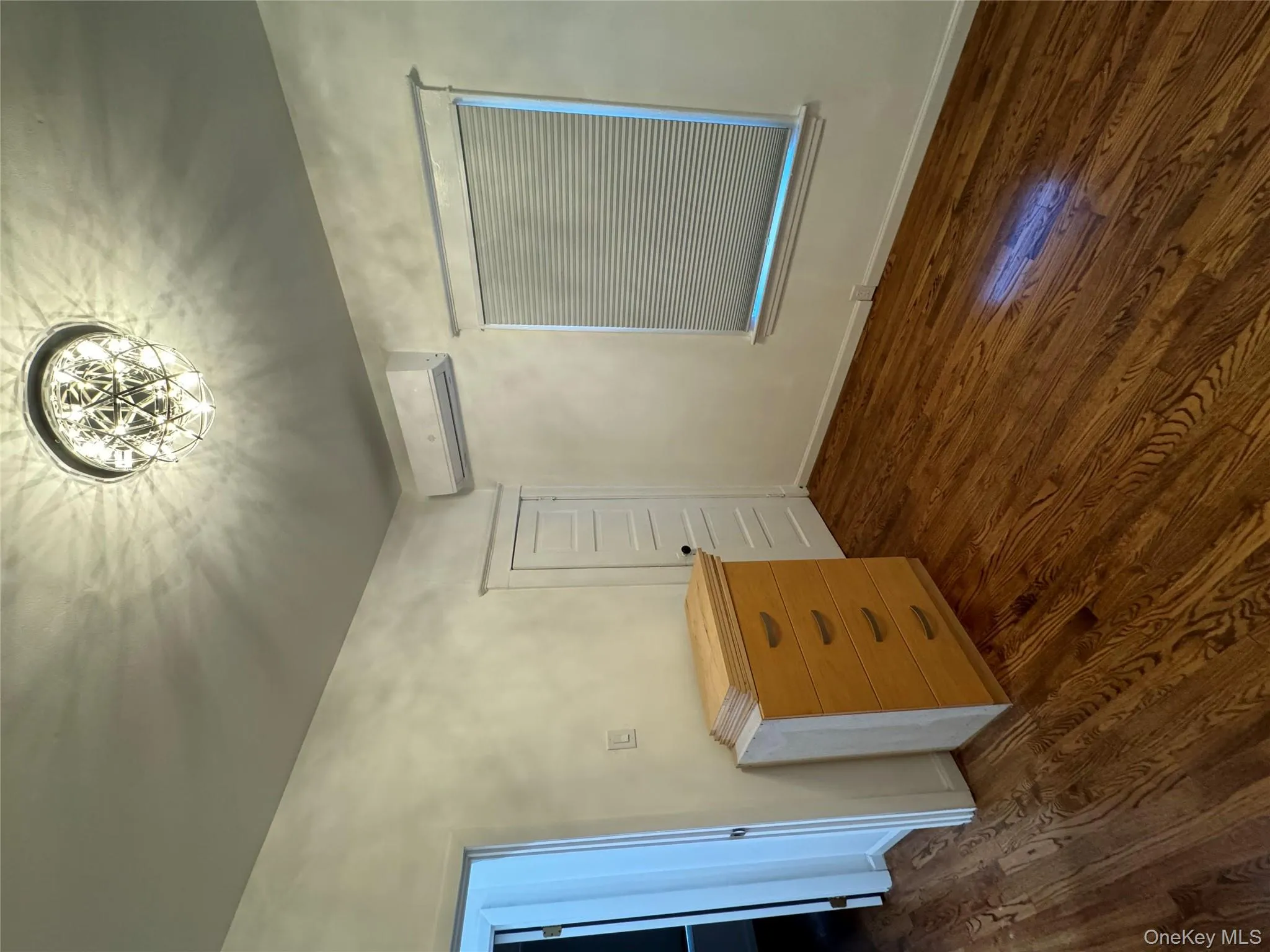 Unfurnished bedroom featuring dark wood-type flooring and a wall unit AC Unfurnished bedroom featuring dark wood-type flooring and a wall unit AC