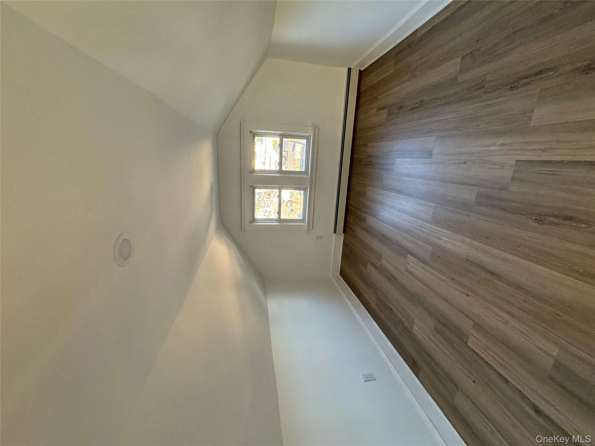 Bonus room featuring dark wood-type flooring, lofted ceiling, and baseboard heating Bonus room featuring dark wood-type flooring, lofted ceiling, and baseboard heating