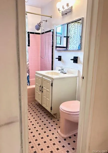Full bath with vanity, shower / bath combination with curtain, and light tile patterned floors Full bath with vanity, shower / bath combination with curtain, and light tile patterned floors