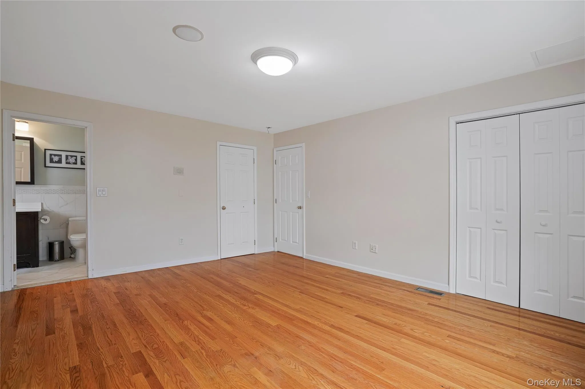 Spacious primary bedroom with walk-closet, plus additional closet and ensuite bathroom. Spacious primary bedroom with walk-closet, plus additional closet and ensuite bathroom.